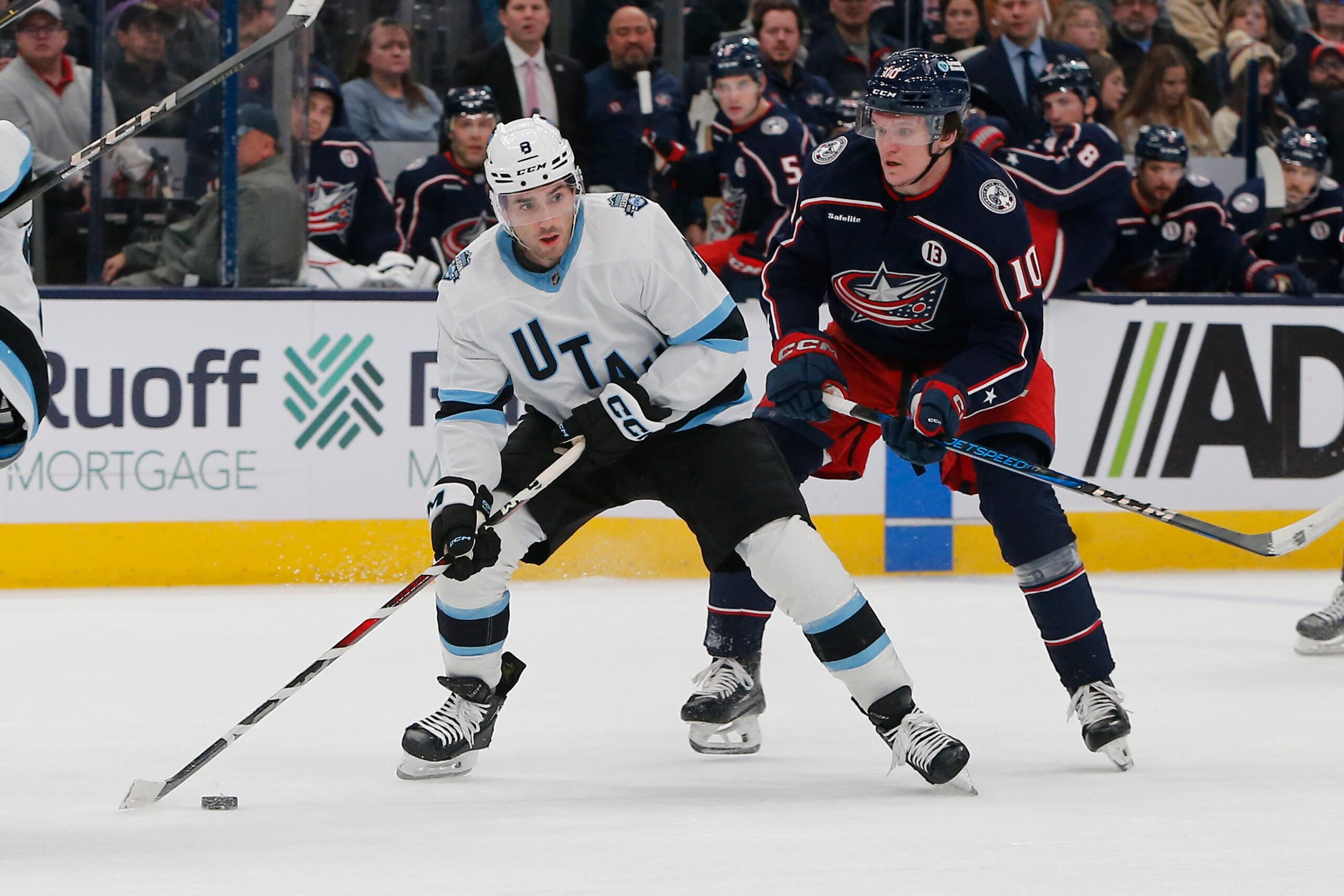 Feb 6, 2025; Columbus, Ohio, USA; Utah Hockey Club center Nick Schmaltz (8) passes against Columbus Blue Jackets left wing Dmitri Voronkov (10) during the first period at Nationwide Arena. Mandatory Credit: Russell LaBounty-Imagn Images