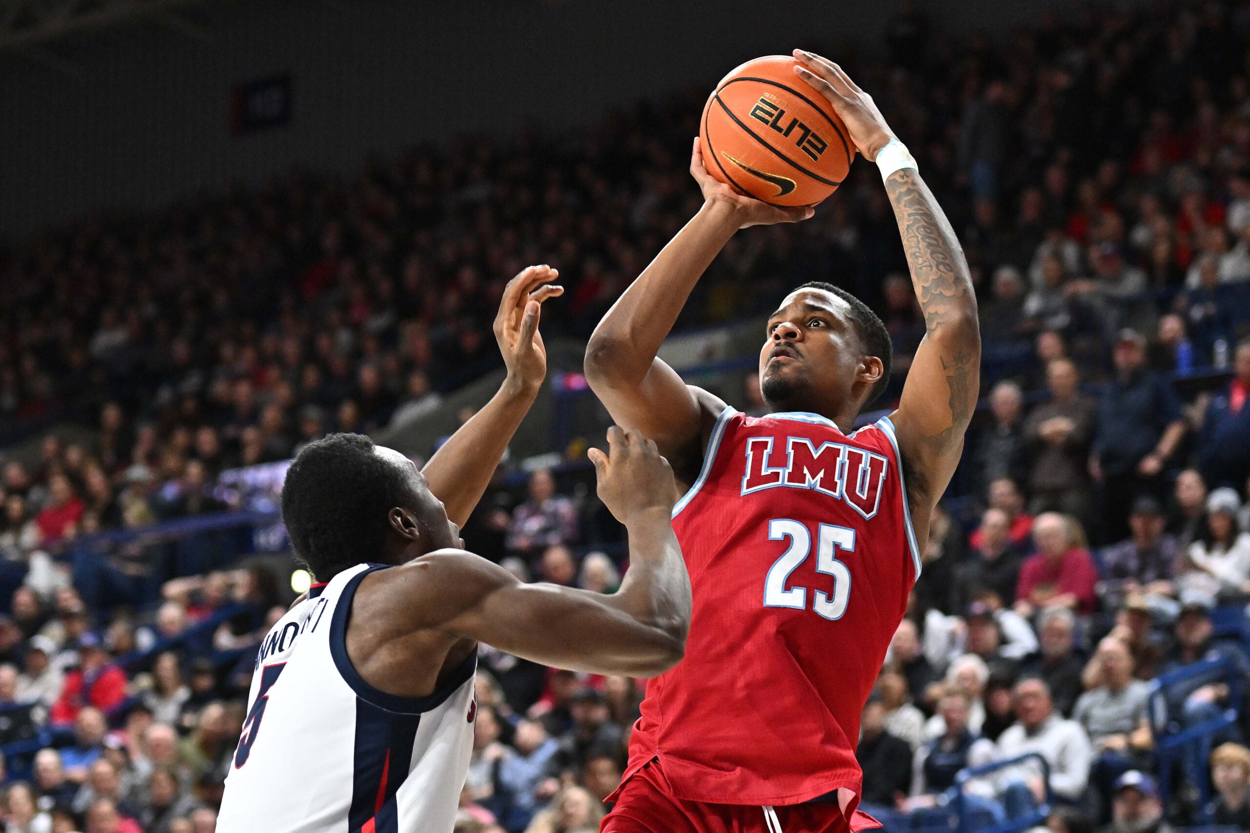 Feb 6, 2025; Spokane, Washington, USA; Loyola Marymount Lions forward Caleb Stone-Carrawell (25) shoots over Gonzaga Bulldogs forward Emmanuel Innocenti (5) in the second half at McCarthey Athletic Center. Gonzaga Bulldogs won 73-53. Mandatory Credit: James Snook-Imagn Images