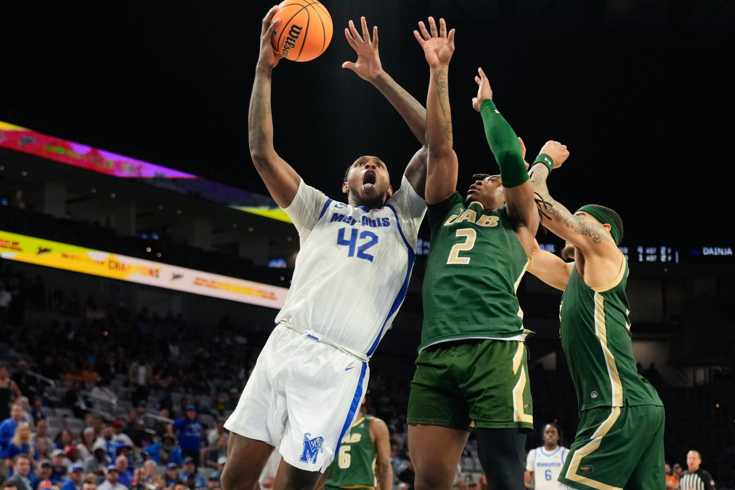 Mar 16, 2025; Fort Worth, TX, USA; Memphis Tigers forward Dain Dainja (42) scores a basket against UAB Blazers guard Ja'Borri McGhee (2) during the second half at Dickies Arena. Mandatory Credit: Chris Jones-Imagn Images