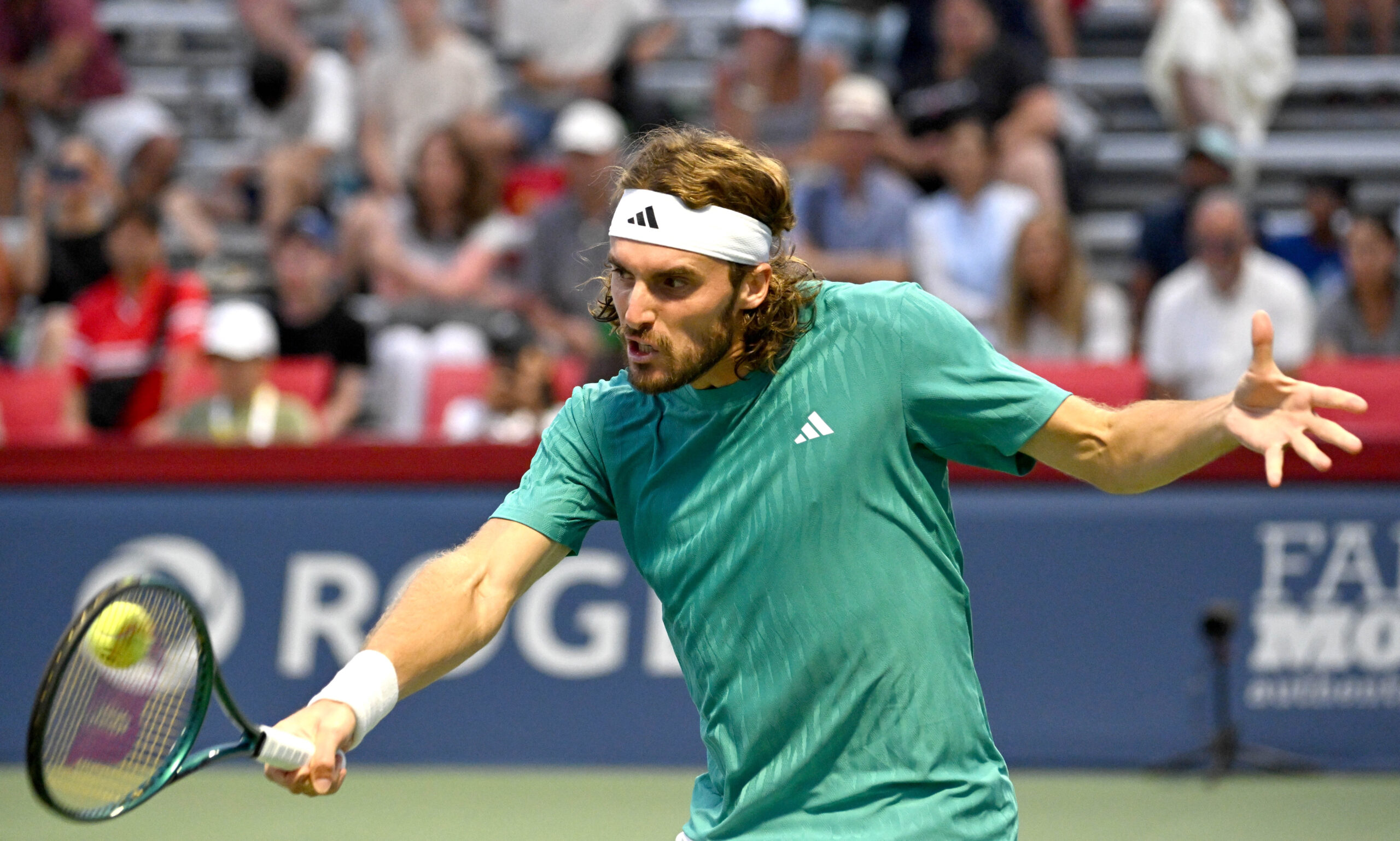 Jul 30, 2025; Toronto, ON, Canada;  Stefanos Tsitsipas (GRE) plays a shot against Christopher O'Connell (AUS) during second round play at Sobeys Stadium. Mandatory Credit: Dan Hamilton-Imagn Images