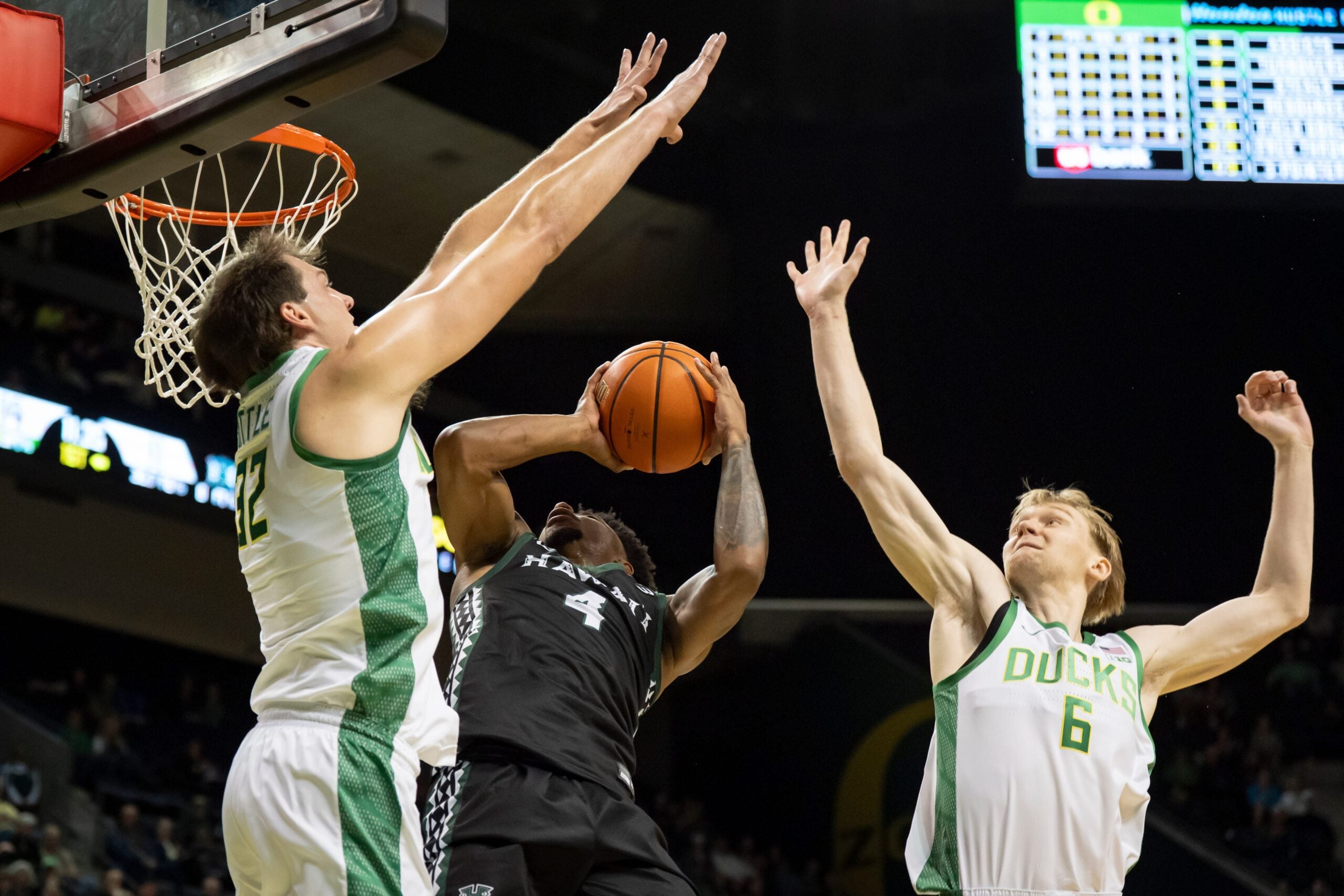 Oregon center Nate Bittle, left, and Oregon forward Oleksandr Kobzystyi block a shot by Hawaii guard Dre Bullock as the Oregon Ducks host the Hawaii Rainbow Warriors on Nov. 4, 2025, at Matthew Knight Arena in Eugene, Oregon.