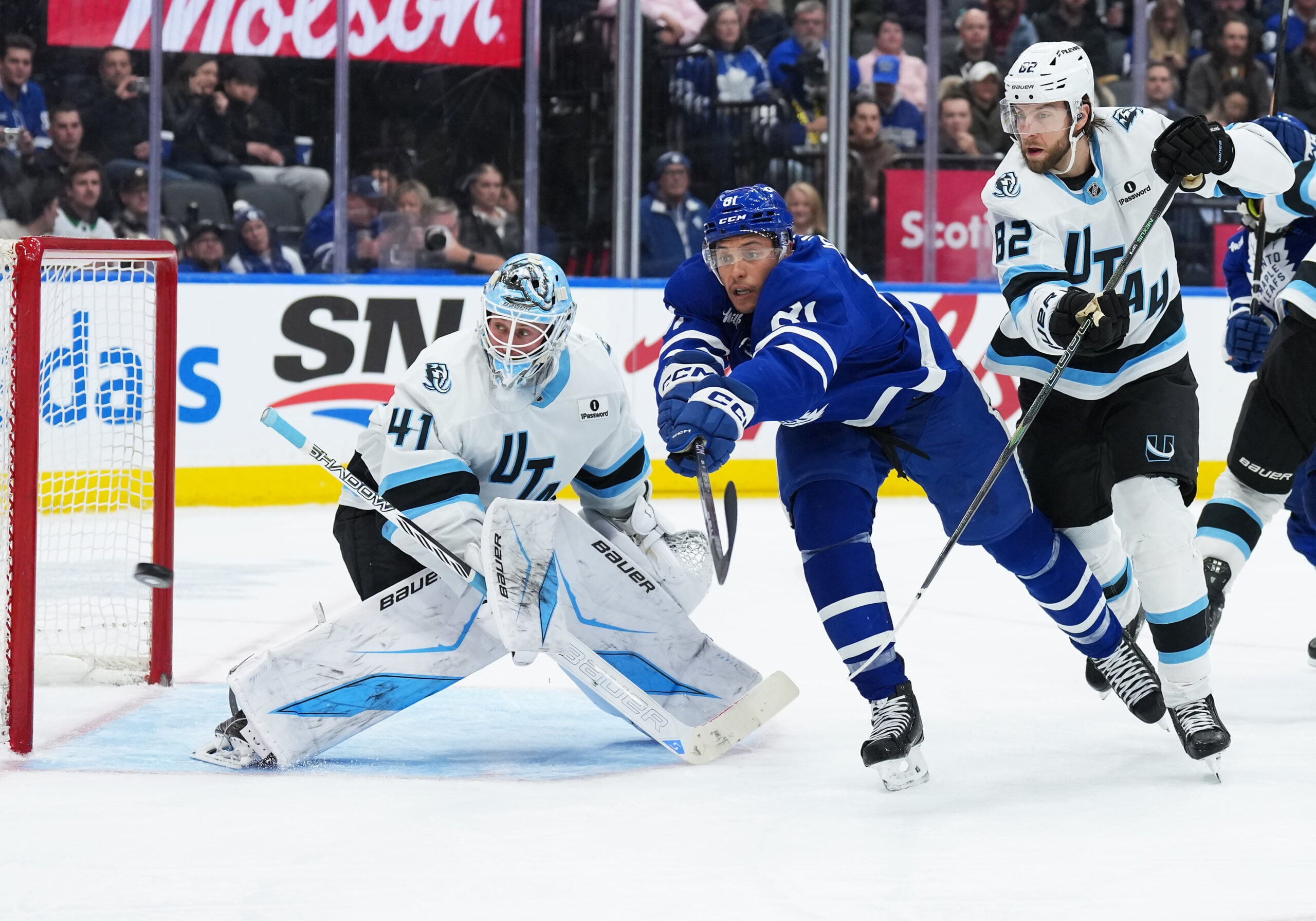 Nov 5, 2025; Toronto, Ontario, CAN; Toronto Maple Leafs center Dakota Joshua (81) battles for the puck with Utah Mammoth center Kevin Stenlund (82) during the third period at Scotiabank Arena. Mandatory Credit: Nick Turchiaro-Imagn Images