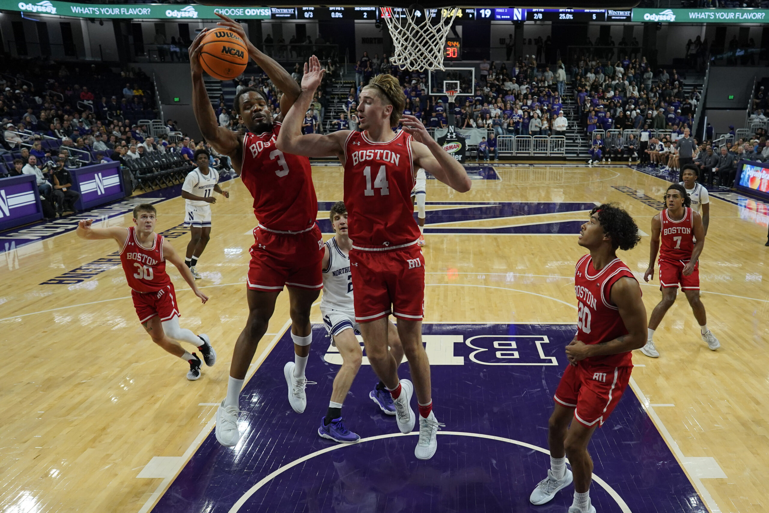Nov 7, 2025; Evanston, Illinois, USA; Boston University Terriers forward Malcolm Chimezie (3) grabs a rebound against the Northwestern Wildcats forward Ben Defty (14) during the first half at Welsh-Ryan Arena. Mandatory Credit: David Banks-Imagn Images