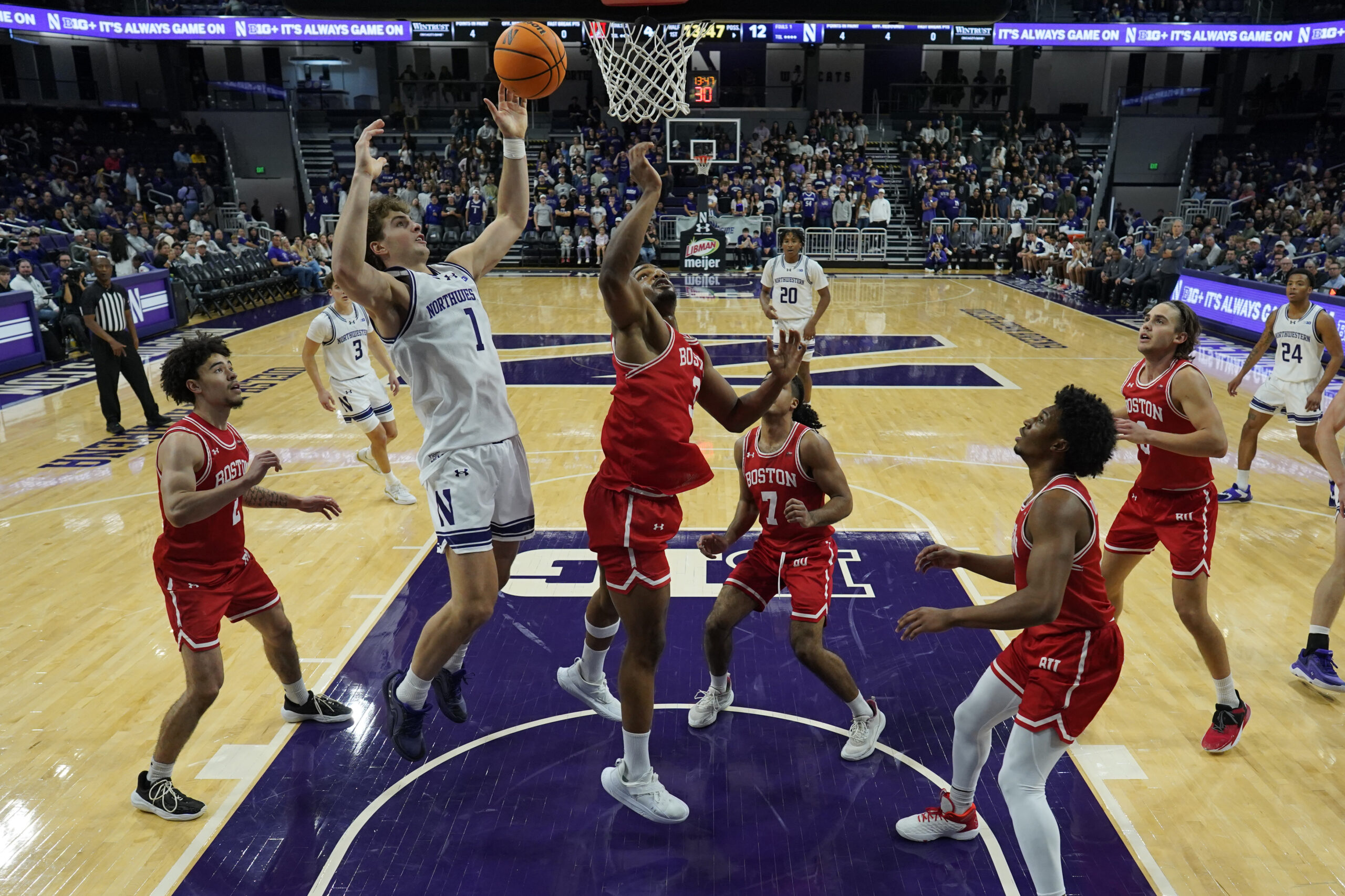 Nov 7, 2025; Evanston, Illinois, USA; Boston University Terriers forward Malcolm Chimezie (3) defends Northwestern Wildcats forward Tyler Kropp (1) during the first half at Welsh-Ryan Arena. Mandatory Credit: David Banks-Imagn Images