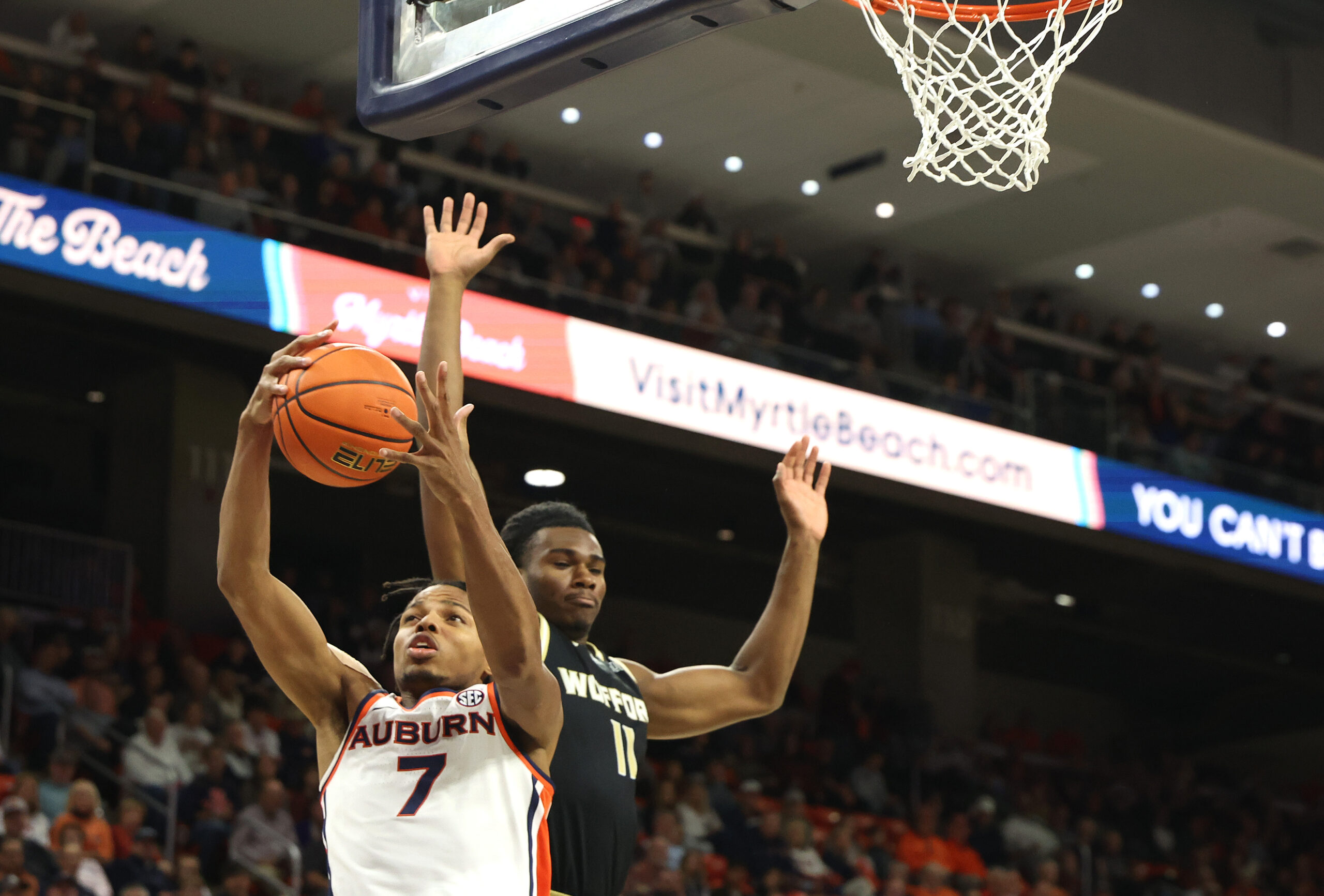 Nov 11, 2025; Auburn, Alabama, USA;  Auburn Tigers guard Keyshawn Hall (7) grabs a rebound from Wofford Terriers guard Kahmare Holmes (11) during the first half at Neville Arena. Mandatory Credit: John Reed-Imagn Images
