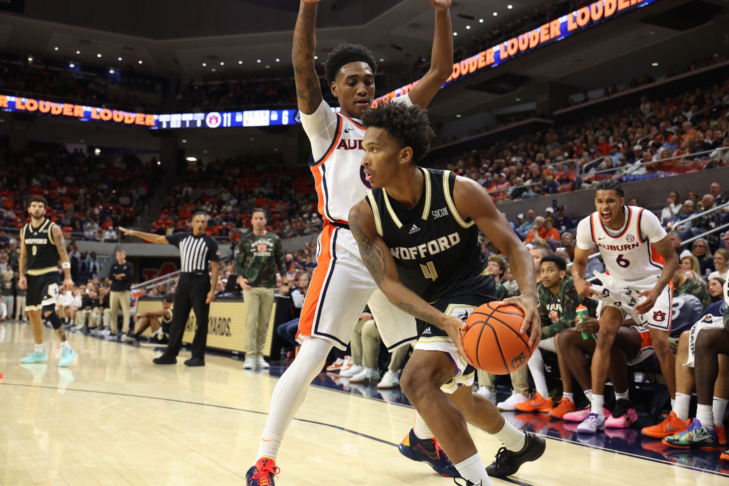 Nov 11, 2025; Auburn, Alabama, USA;  Wofford Terriers guard Chace Watley (4) looks for help as Auburn Tigers guard Tahaad Pettiford (0) defends during the first half at Neville Arena. Mandatory Credit: John Reed-Imagn Images