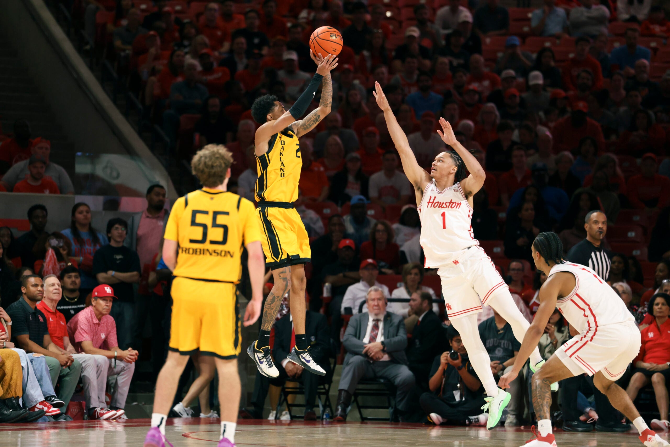 Nov 12, 2025; Houston, Texas, USA; Oakland Golden Grizzlies guard Ziare Wells (2) shoots the ball as Houston Cougars guard Isiah Harwell (1) defends during the first half at Fertitta Center. Mandatory Credit: Troy Taormina-Imagn Images