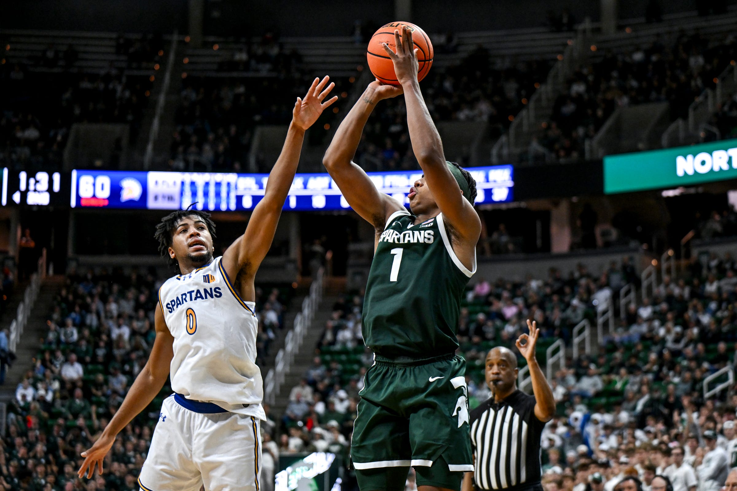Michigan State's Jeremy Fears Jr., right, makes a 3-pointer as San Jose State's Colby Garland defends during the second half on Thursday, Nov. 13, 2025, at the Breslin Center in East Lansing.