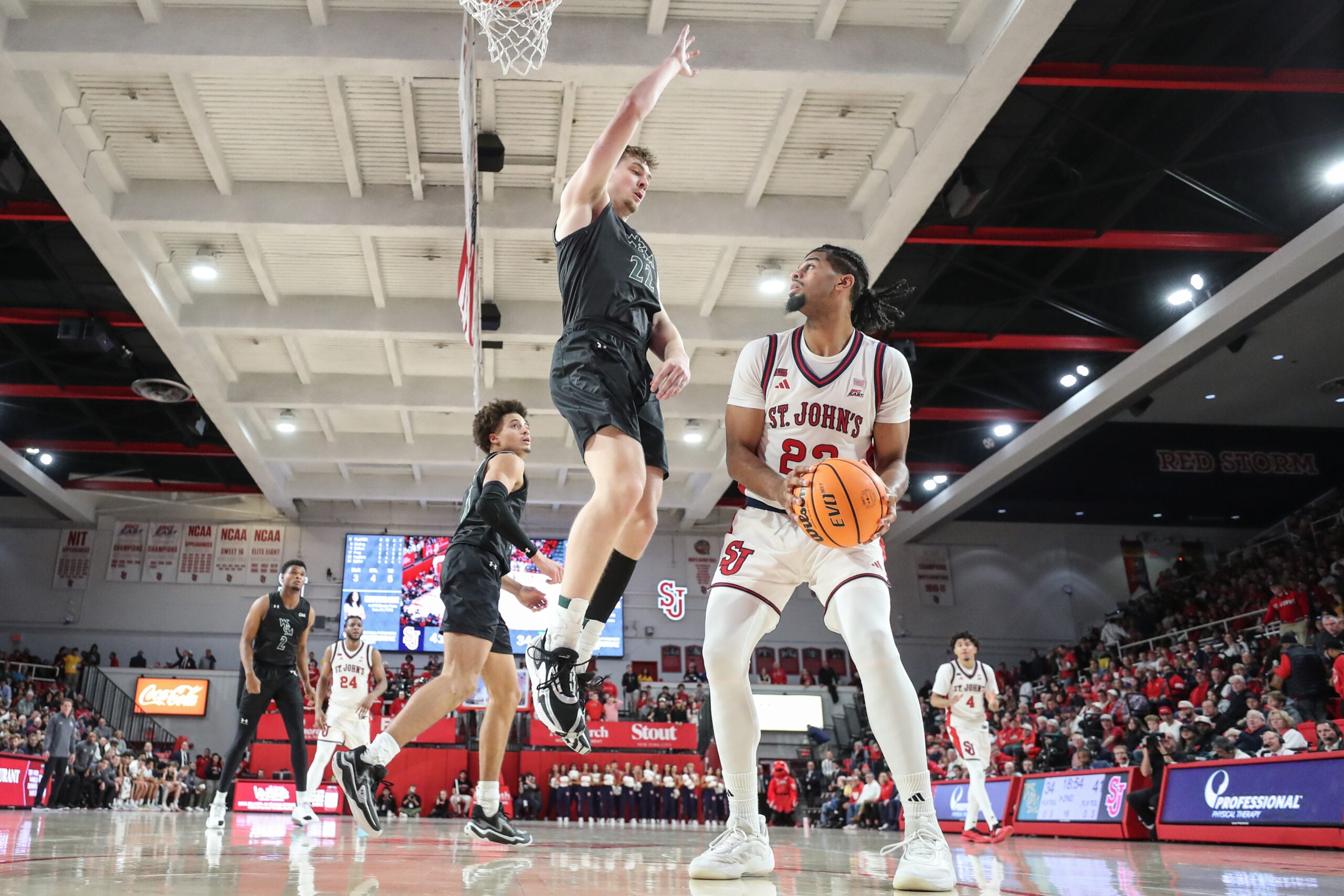 Nov 15, 2025; Queens, New York, USA;  St. John's Red Storm forward Bryce Hopkins (23) looks to post up against William & Mary Tribe forward Kilian Brockhoff (22) in the second half at Carnesecca Arena. Mandatory Credit: Wendell Cruz-Imagn Images