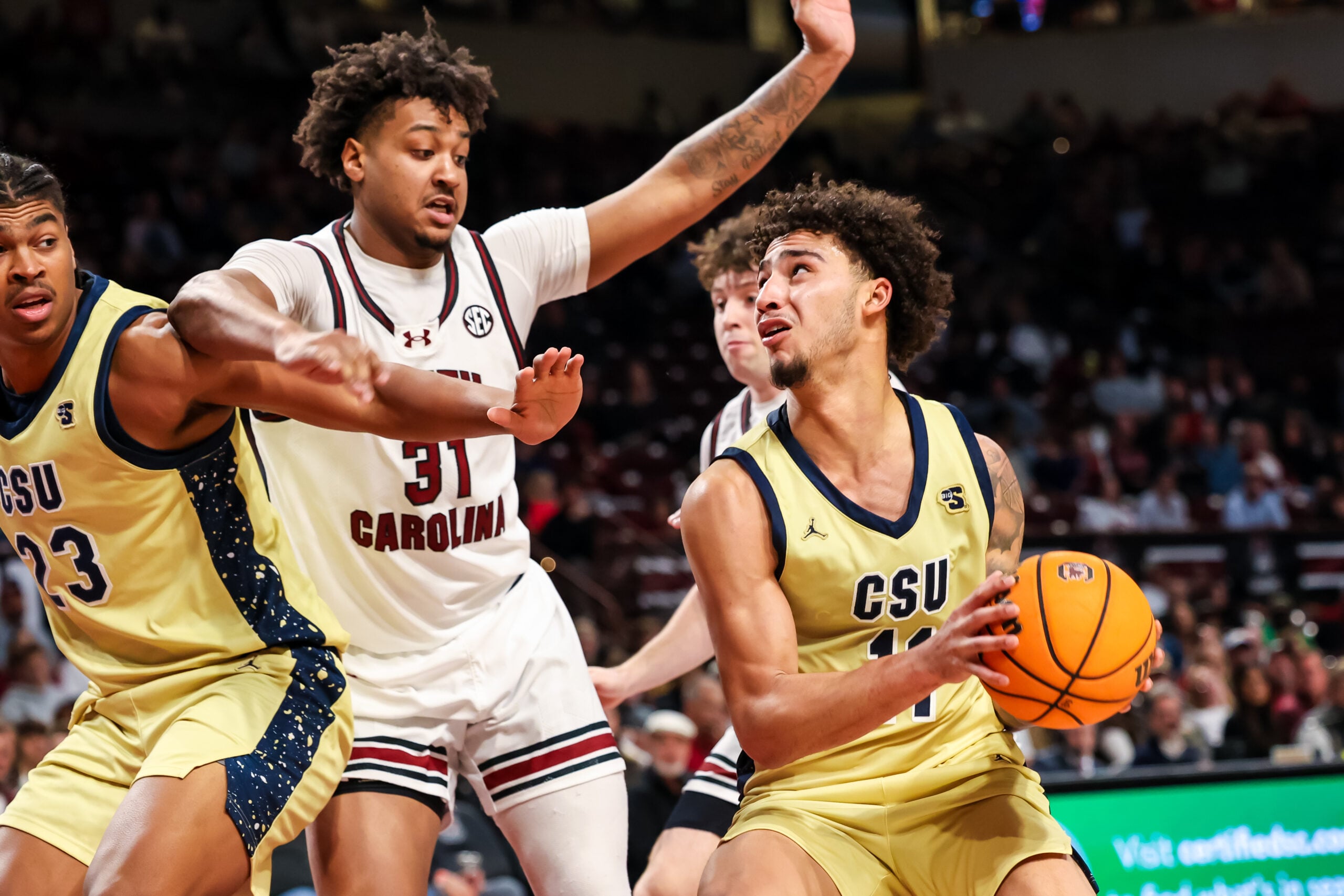 Nov 28, 2025; Columbia, South Carolina, USA; Charleston Southern Buccaneers guard Brycen Blaine (11) attempts to shoot over South Carolina Gamecocks forward Elijah Strong (31) in the second half at Colonial Life Arena. Mandatory Credit: Jeff Blake-Imagn Images