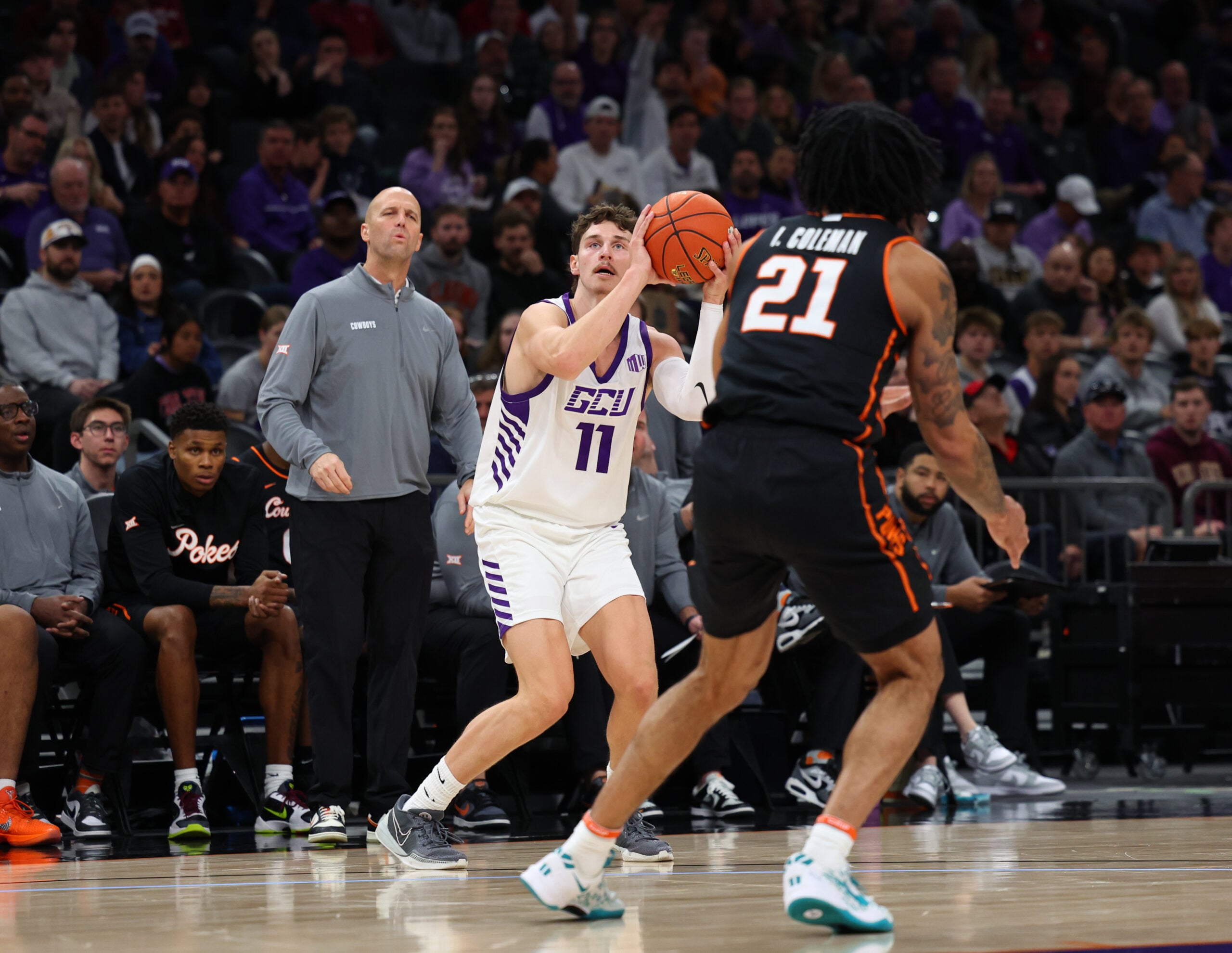 Dec 6, 2025; Phoenix, Arizona, USA; Grand Canyon Lopes guard Caleb Shaw (11) attempts a 3-point shot against the Oklahoma State Cowboys at PHX Arena. Mandatory Credit: Anna Carrington-Imagn Images