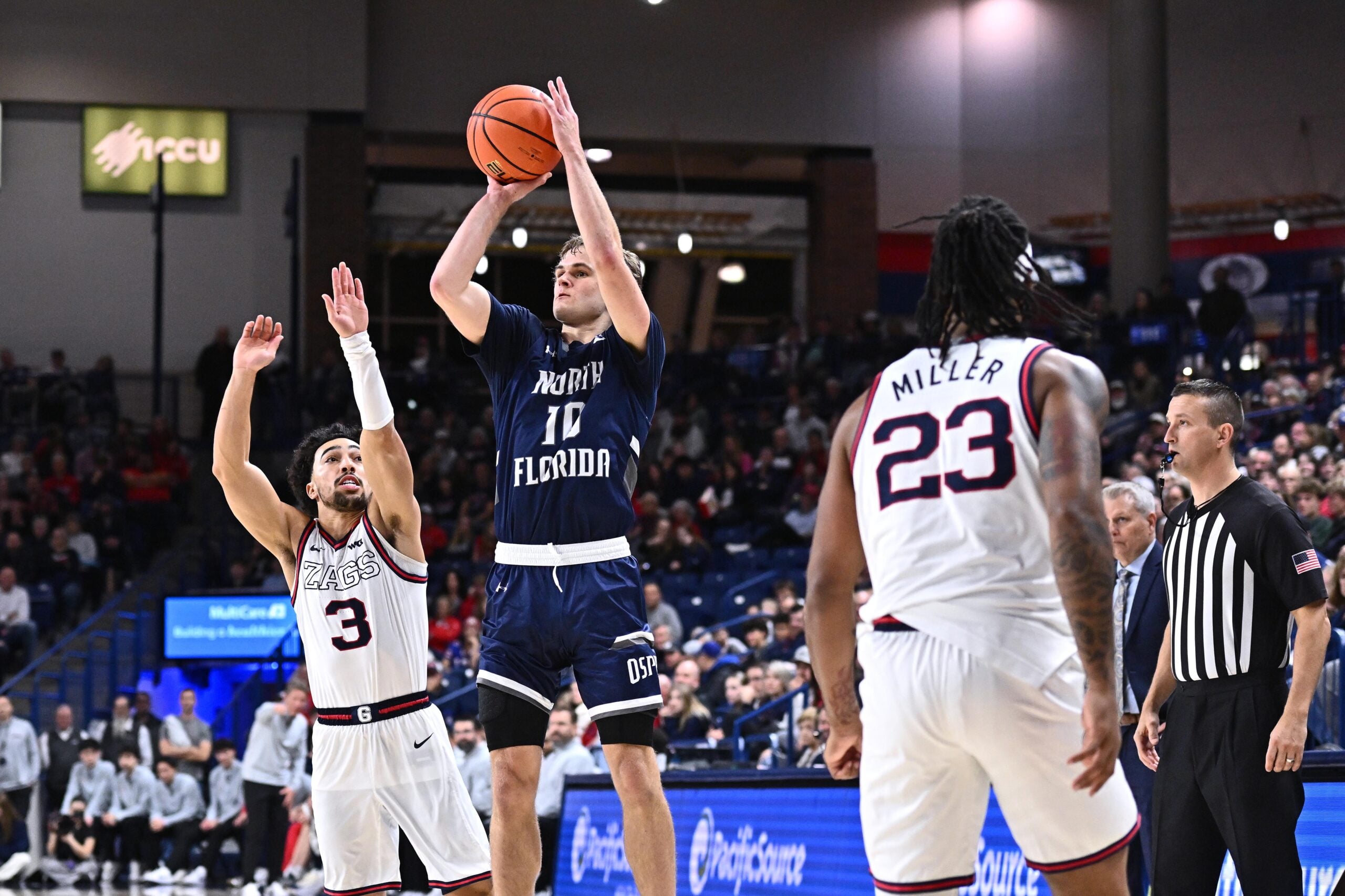 Dec 7, 2025; Spokane, Washington, USA; North Florida Ospreys guard Kent Jackson (10) shoots the ball against Gonzaga Bulldogs guard Braeden Smith (3) in the second half at McCarthey Athletic Center. Mandatory Credit: James Snook-Imagn Images