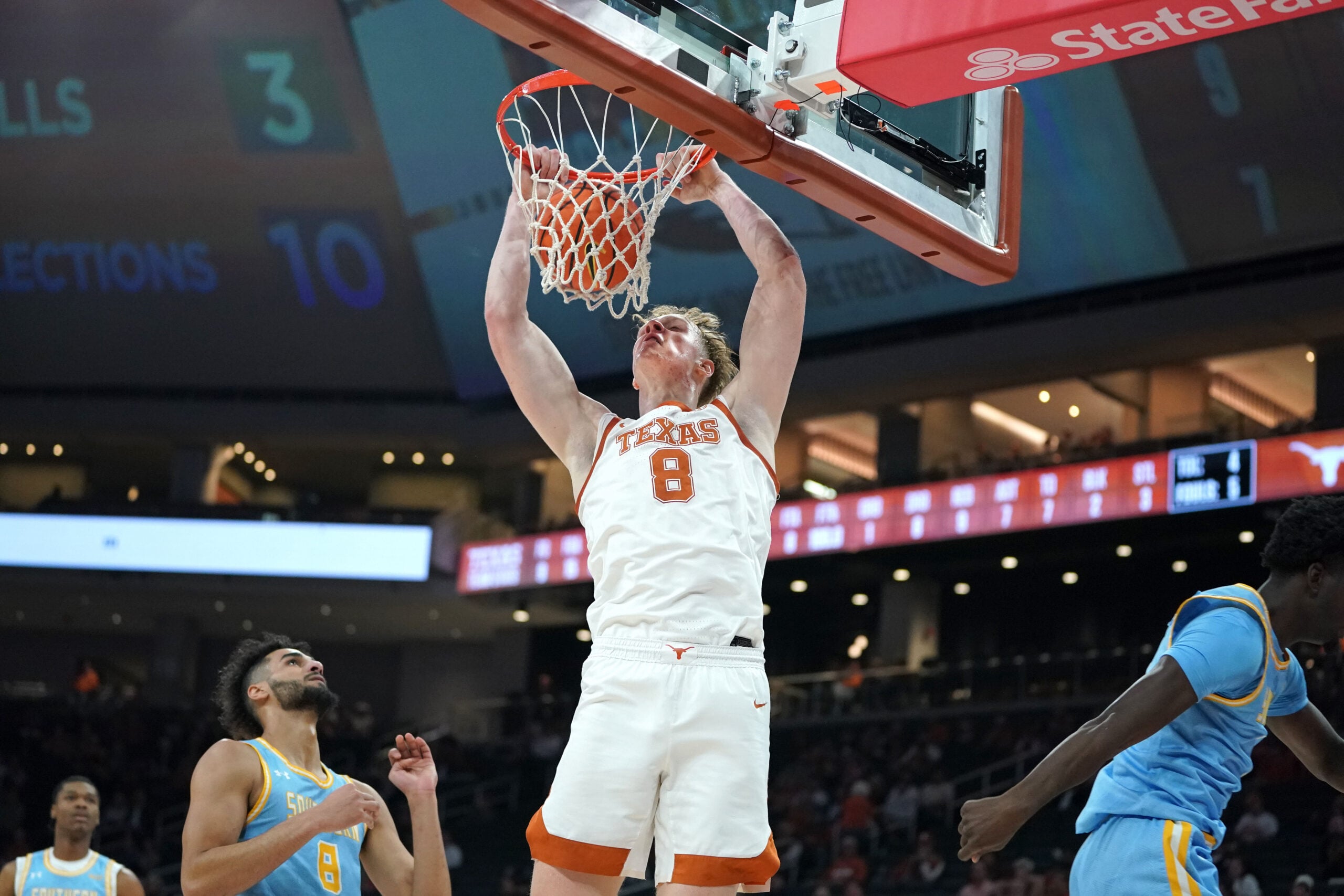 Dec 8, 2025; Austin, Texas, USA; Texas Longhorns center Matas Vokietaitis (8) dunks the ball against Southern University Jaguars forward Malek Abdelgowad (8) during the first half at Moody Center. Mandatory Credit: Dustin Safranek-Imagn Images