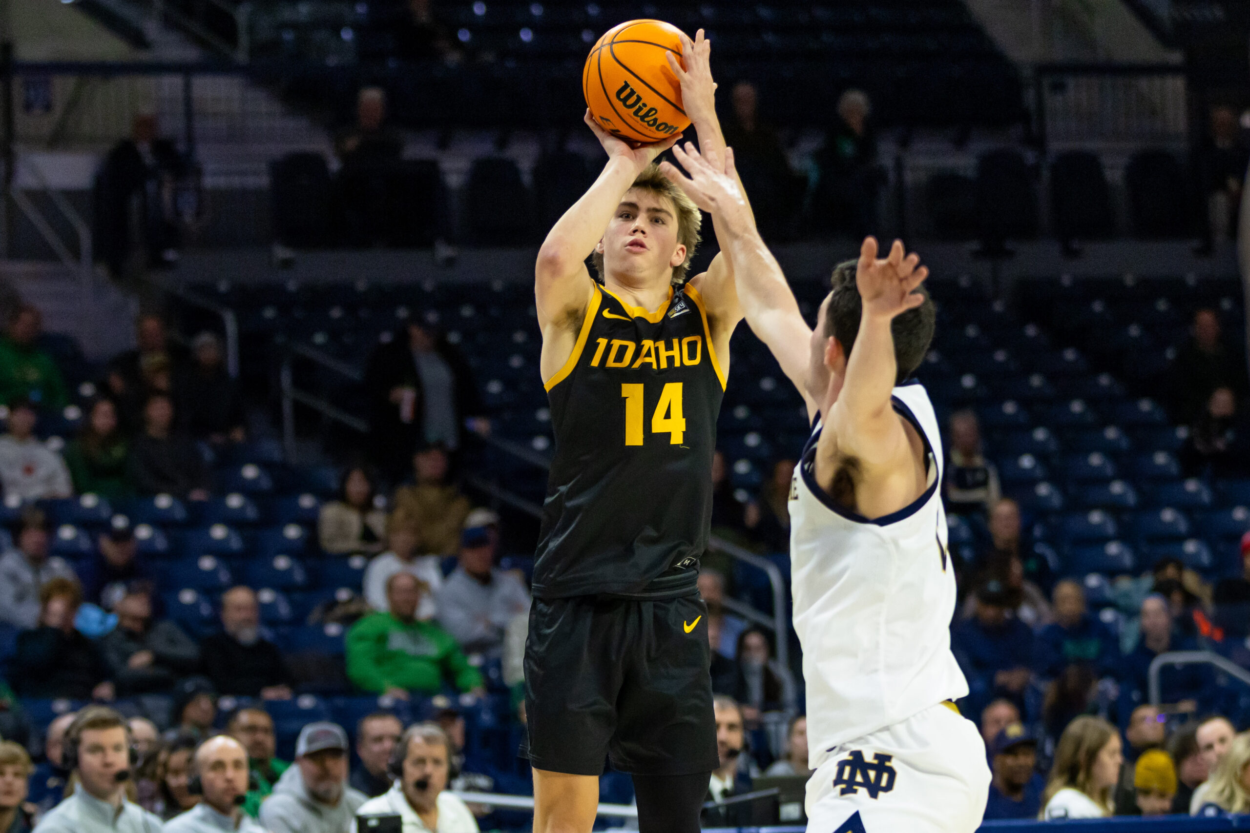 Dec 10, 2025; South Bend, Indiana, USA; Idaho Vandals guard Kolton Mitchell (14) shoots as Notre Dame Fighting Irish guard Logan Imes (2) defends during the second half at Purcell Pavilion at the Joyce Center. Mandatory Credit: Michael Caterina-Imagn Images