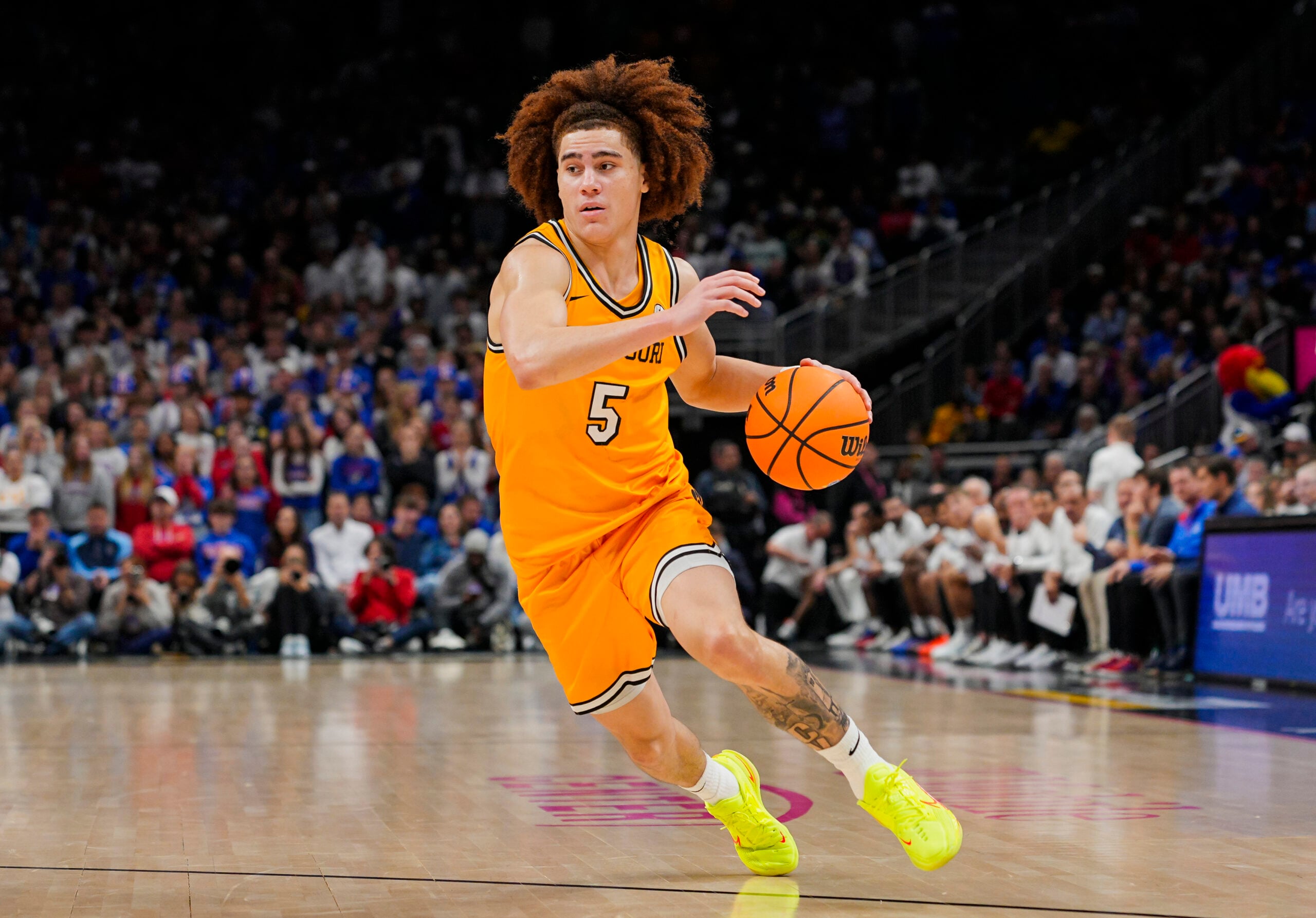 Dec 7, 2025; Kansas City, Missouri, USA; Missouri Tigers guard T.O. Barrett (5) dribbles the ball during the second half against the Kansas Jayhawks at T-Mobile Center. Mandatory Credit: Jay Biggerstaff-Imagn Images