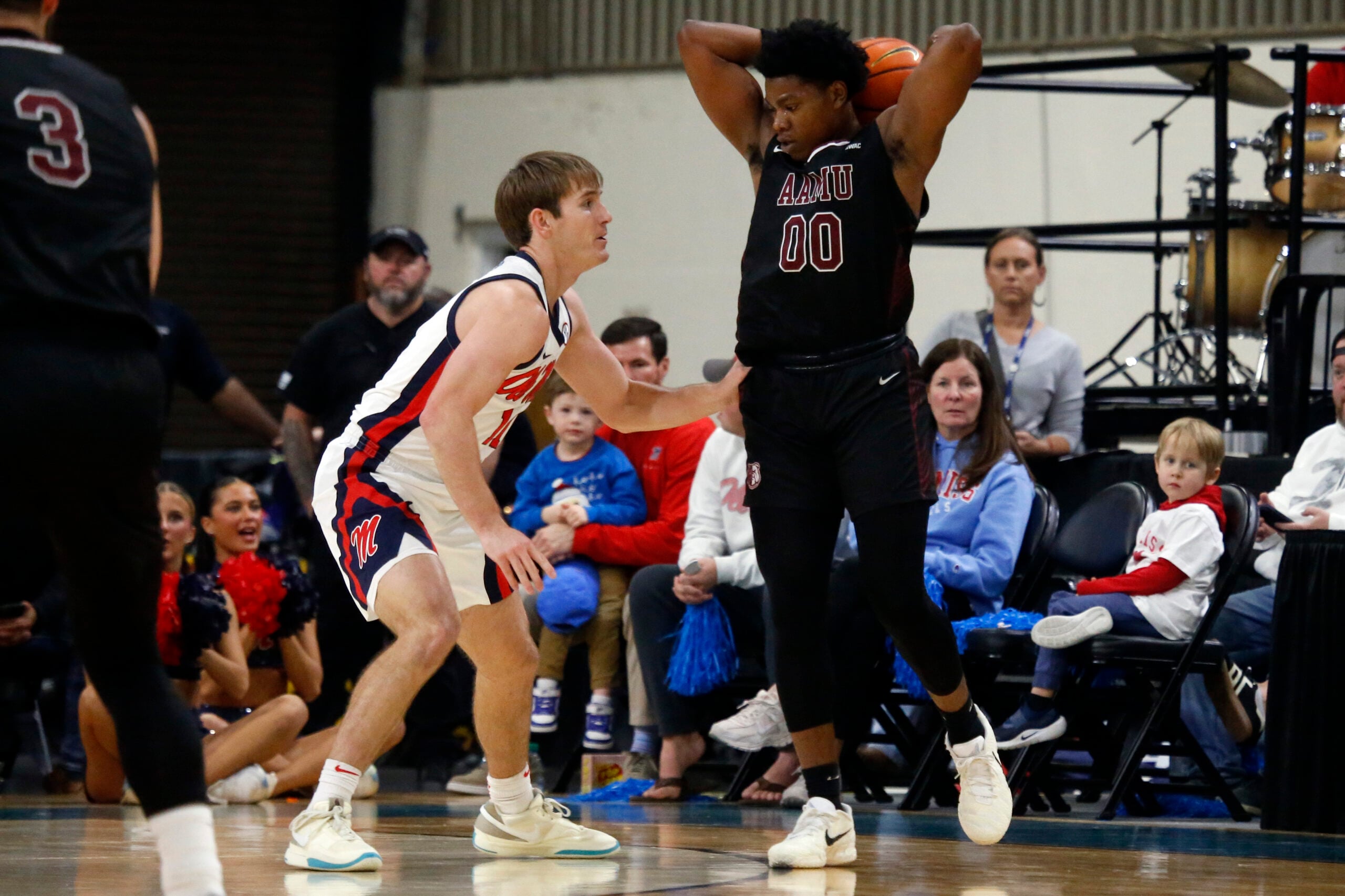 Dec 17, 2025; Tupelo, Mississippi, USA; Alabama A&M Bulldogs guard Kintavious Dozier (0) handles the ball as Mississippi Rebels guard Travis Perry (11) defends during the first half at Cadence Bank Arena. Mandatory Credit: Petre Thomas-Imagn Images