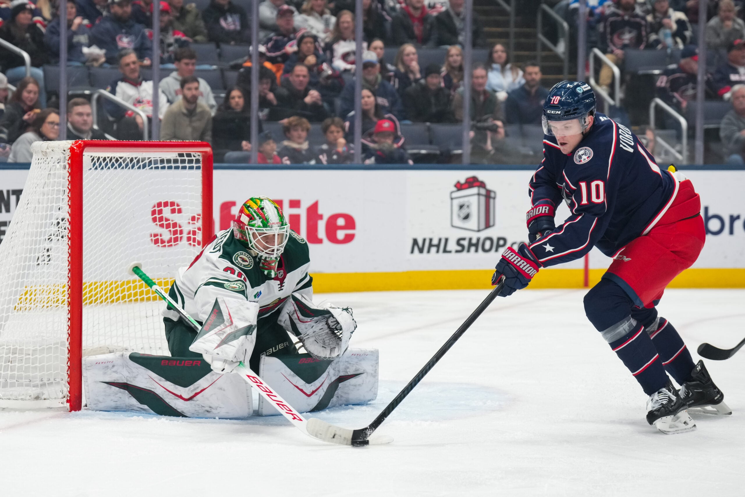 Dec 18, 2025; Columbus, Ohio, USA;  Minnesota Wild goaltender Jesper Wallstedt (30) defends the net against Columbus Blue Jackets left wing Dmitri Voronkov (10) in the first period at Nationwide Arena. Mandatory Credit: Aaron Doster-Imagn Images