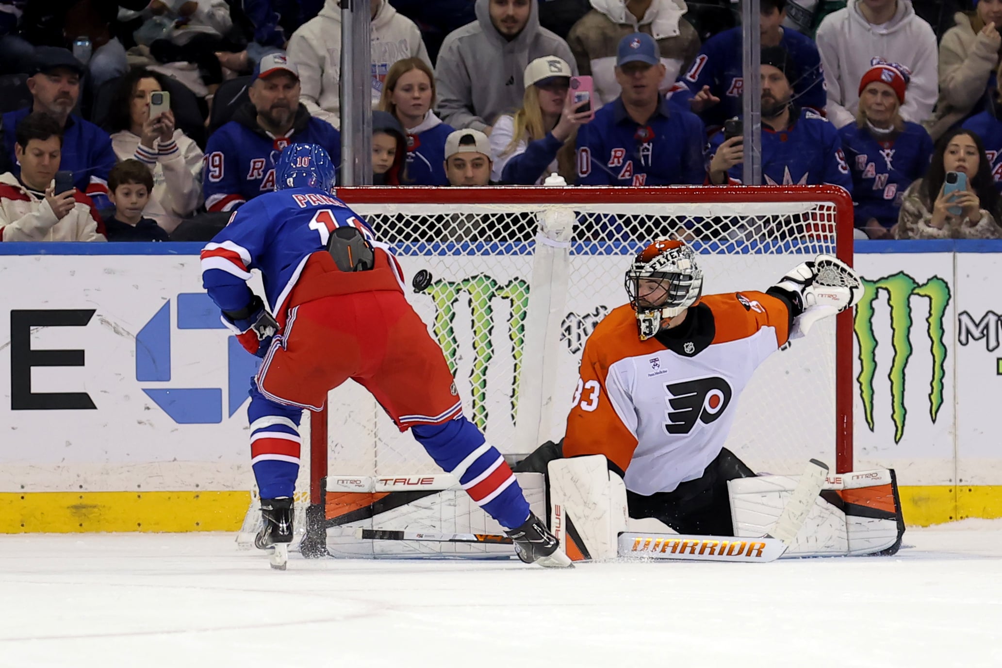 Dec 20, 2025; New York, New York, USA; New York Rangers left wing Artemi Panarin (10) scores against Philadelphia Flyers goaltender Samuel Ersson (33) during the shootout at Madison Square Garden. Mandatory Credit: Brad Penner-Imagn Images