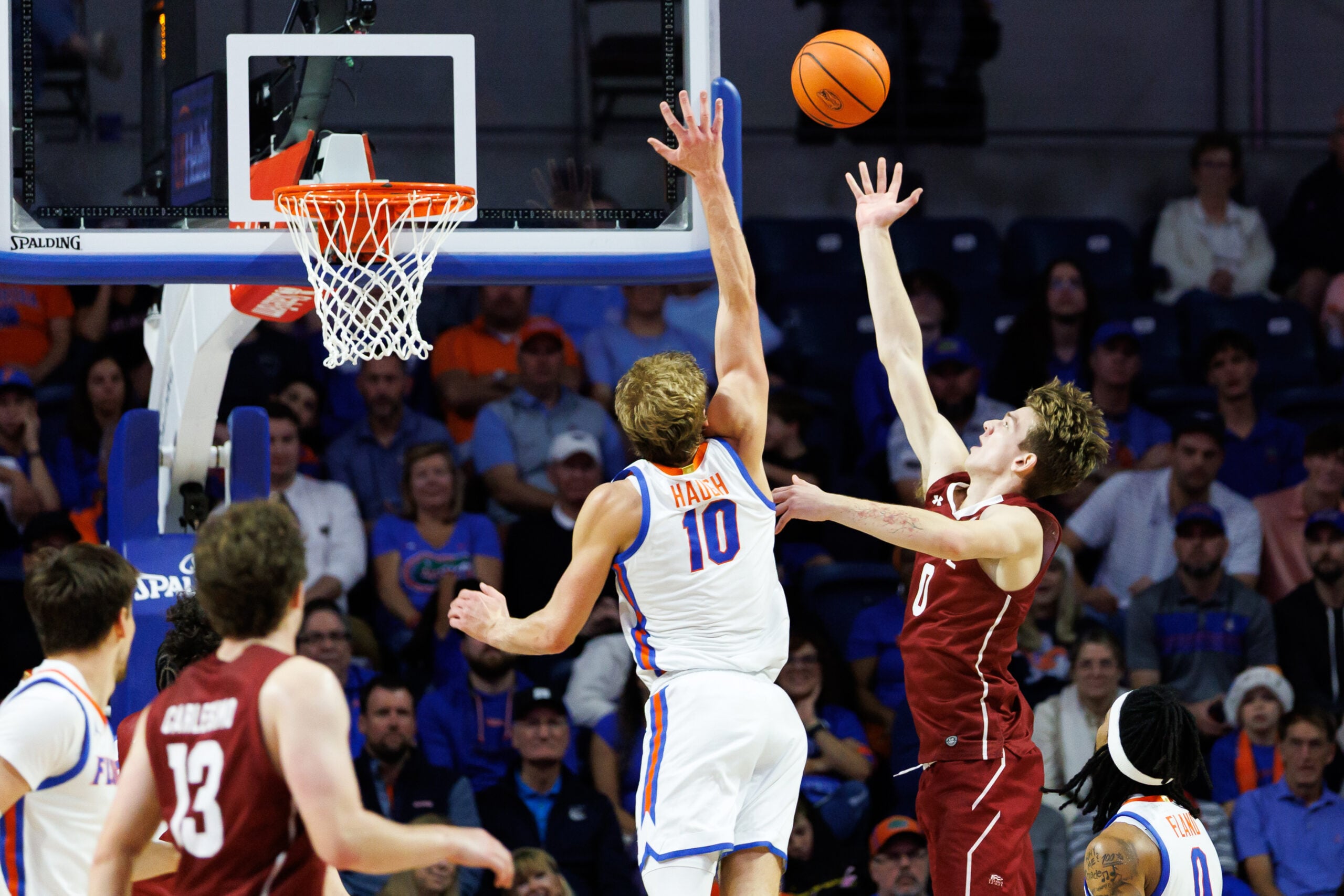 Dec 21, 2025; Gainesville, Florida, USA; Colgate Raiders forward Ethan Brown (0) shoots over Florida Gators forward Thomas Haugh (10) during the second half at Exactech Arena at the Stephen C. O'Connell Center. Mandatory Credit: Matt Pendleton-Imagn Images