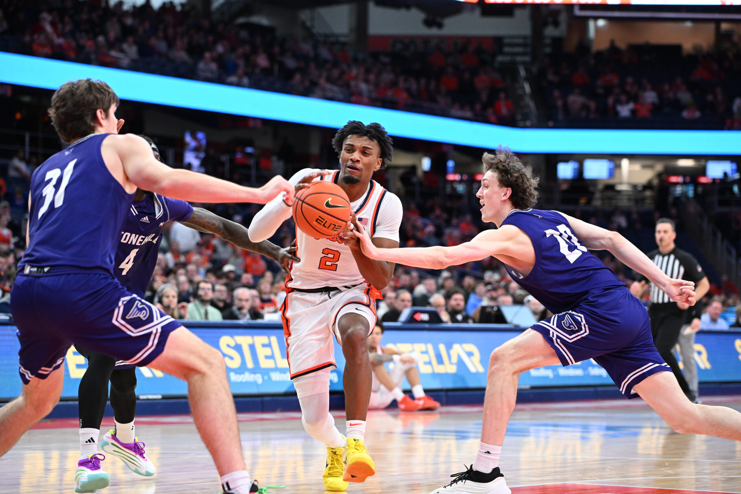 Dec 22, 2025; Syracuse, New York, USA; Syracuse Orange guard J.J. Starling (2) drives to the basket between Stonehill Skyhawks forward Cory Lovell (20) and forward Pearse McGuinn (31) in the second half at the JMA Wireless Dome. Mandatory Credit: Mark Konezny-Imagn Images