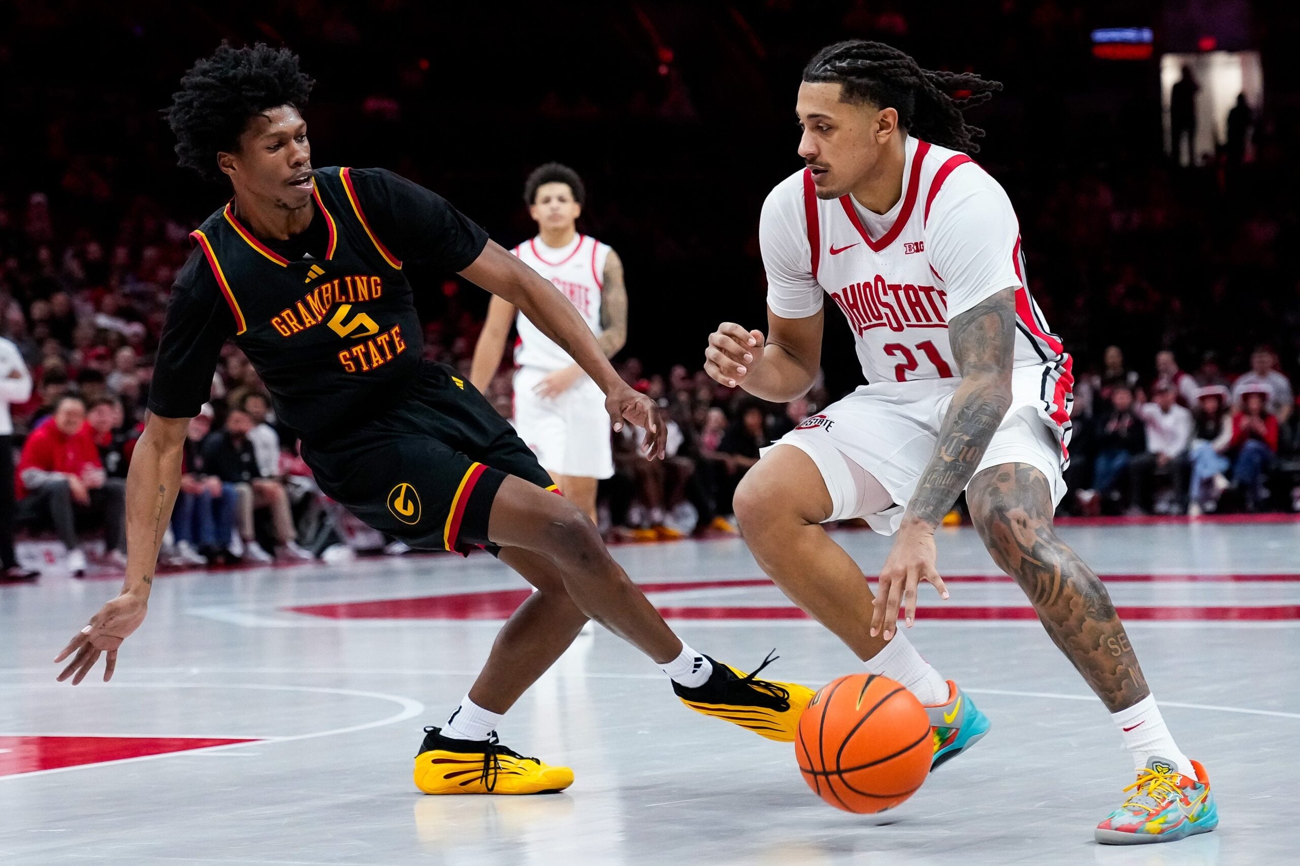 Ohio State Buckeyes forward Devin Royal (21) moves the ball past Grambling State Tigers Jimel Lane (5) in the second half of the NCAA men’s basketball game Value City Arena on Tuesday, Dec. 23, 2025 in Columbus, Ohio.