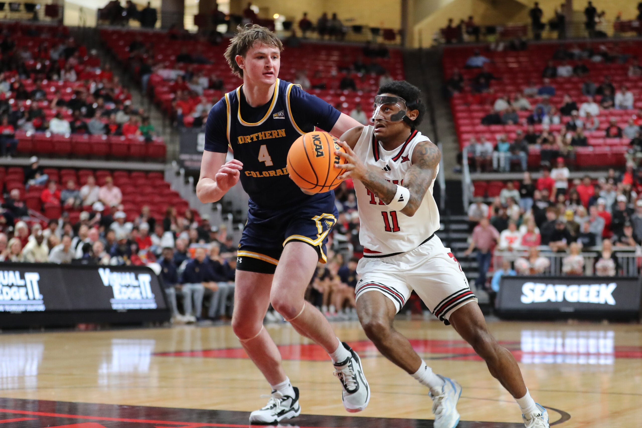 Dec 16, 2025; Lubbock, Texas, USA; Texas Tech Red Raiders guard Jaylen Petty (11) drives to the basket against Northern Colorado Bears center Hunter Caldwell (4) in the second half at United Supermarkets Arena. Mandatory Credit: Michael C. Johnson-Imagn Images