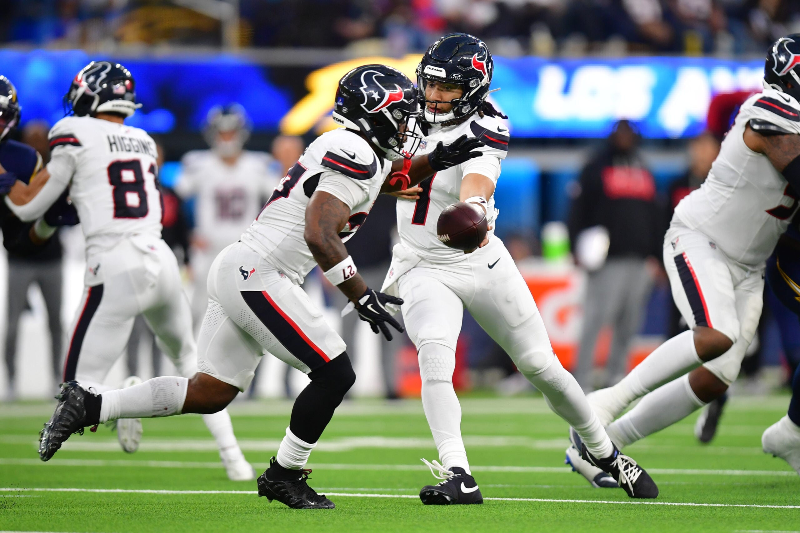 Dec 27, 2025; Inglewood, California, USA;  Houston Texans running back Woody Marks (27) takes the hand off from quarterback C.J. Stroud (7) against the Los Angeles Chargers during the second half at SoFi Stadium. Mandatory Credit: Gary A. Vasquez-Imagn Images