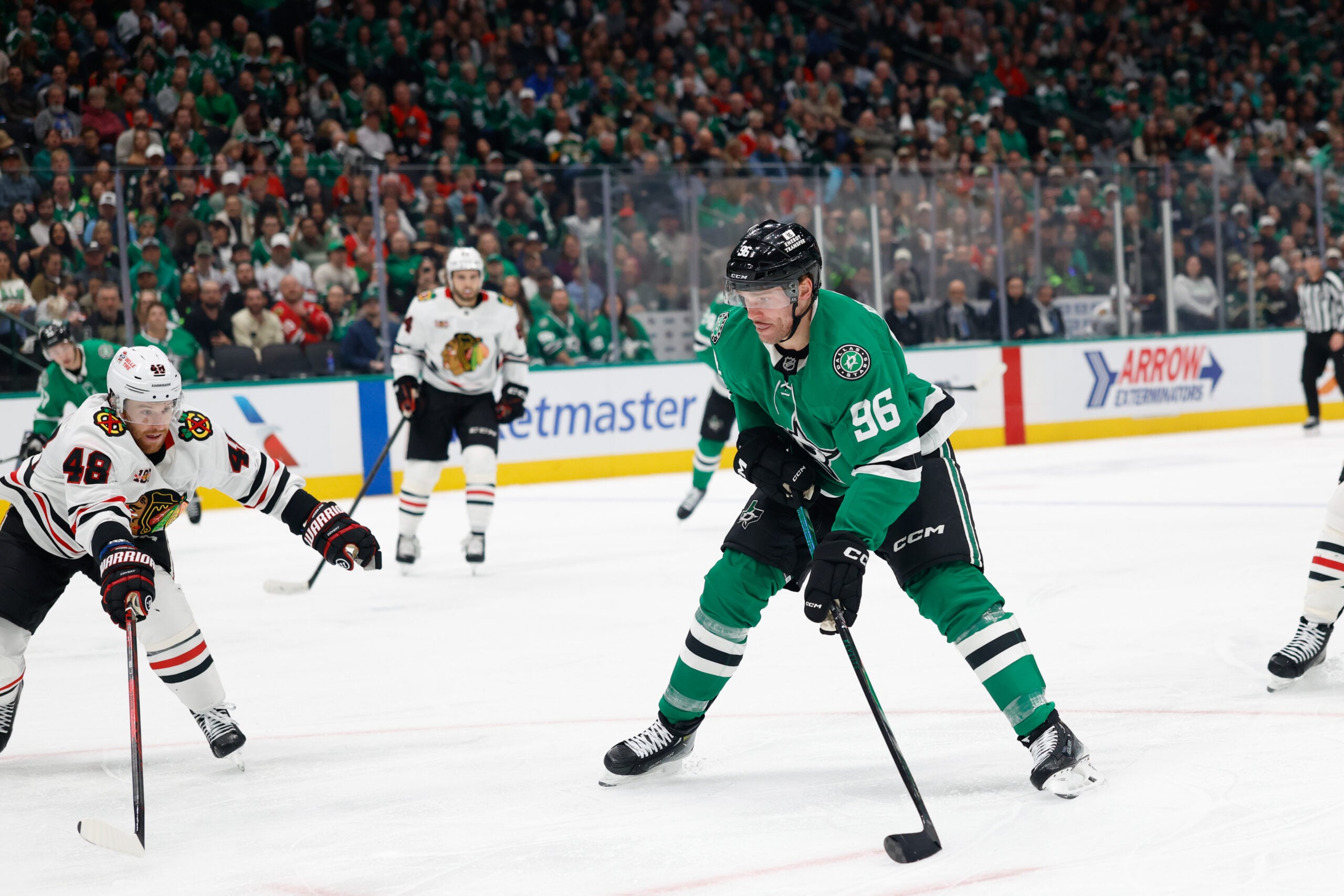 Dec 27, 2025; Dallas, Texas, USA; Dallas Stars right wing Mikko Rantanen (96) shoots the puck against Chicago Blackhawks defenseman Matt Grzelcyk (48) during the second period at American Airlines Center. Mandatory Credit: Chris Jones-Imagn Images