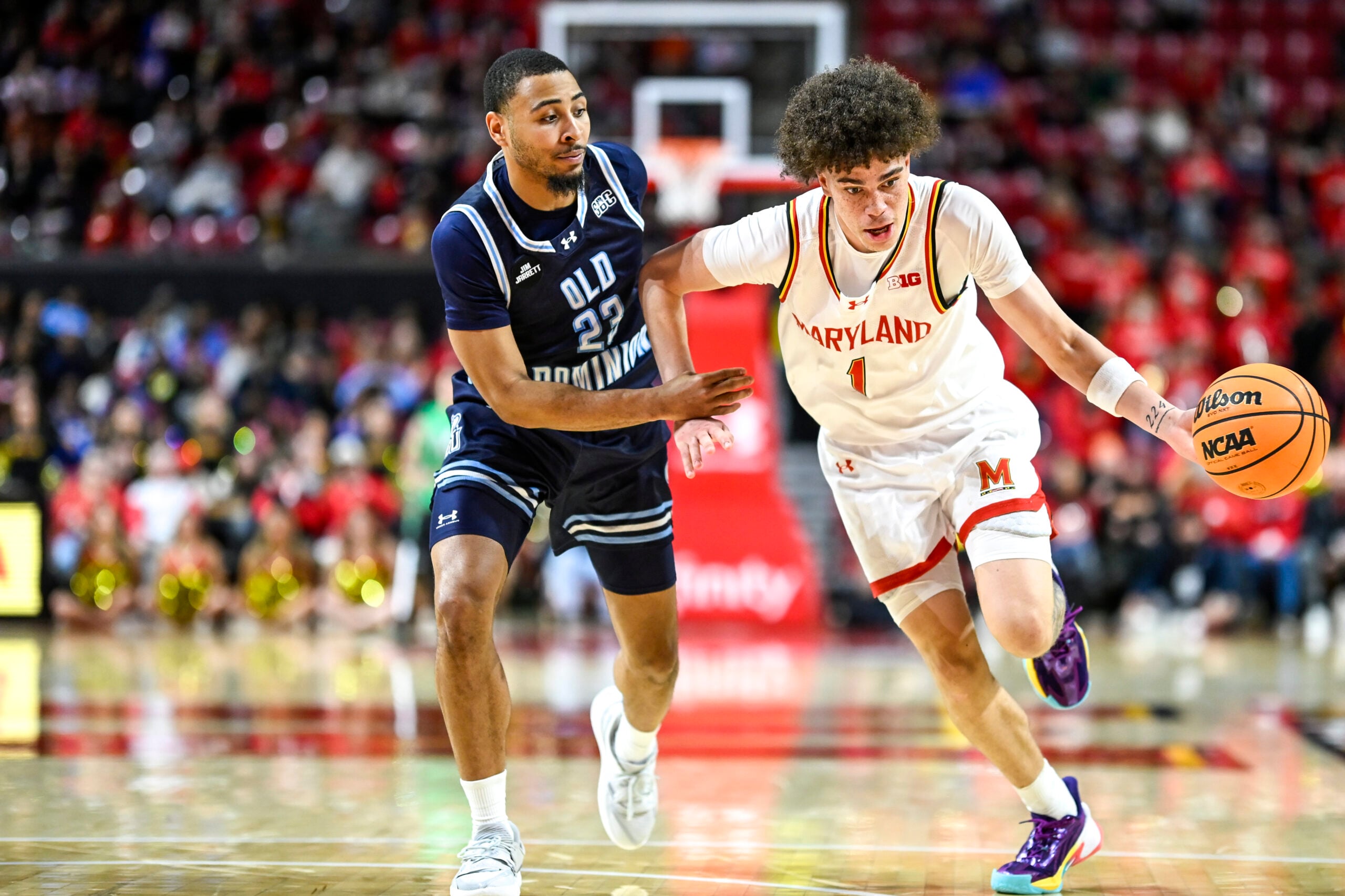 Dec 28, 2025; College Park, Maryland, USA; Maryland Terrapins guard Darius Adams (1) drives to the basket on Old Dominion Monarchs guard Jordan Battle (23) during the second half  at Xfinity Center. Mandatory Credit: Tommy Gilligan-Imagn Images