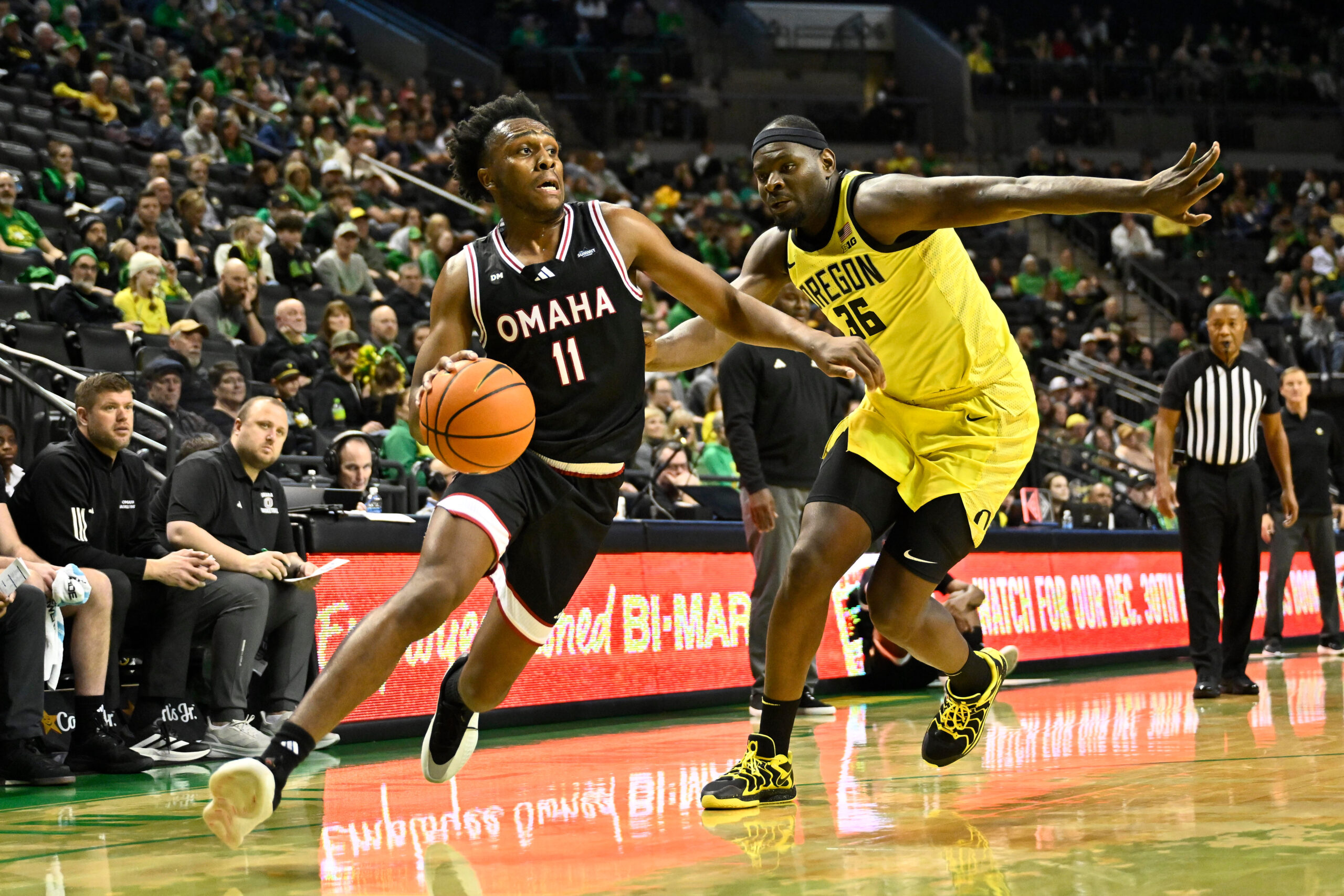 Dec 28, 2025; Eugene, Oregon, USA; Omaha Mavericks guard Paul Djobet (11) drives to the basket against Oregon Ducks center Ege Demir (36) during the second half at Matthew Knight Arena. Mandatory Credit: Craig Strobeck-Imagn Images