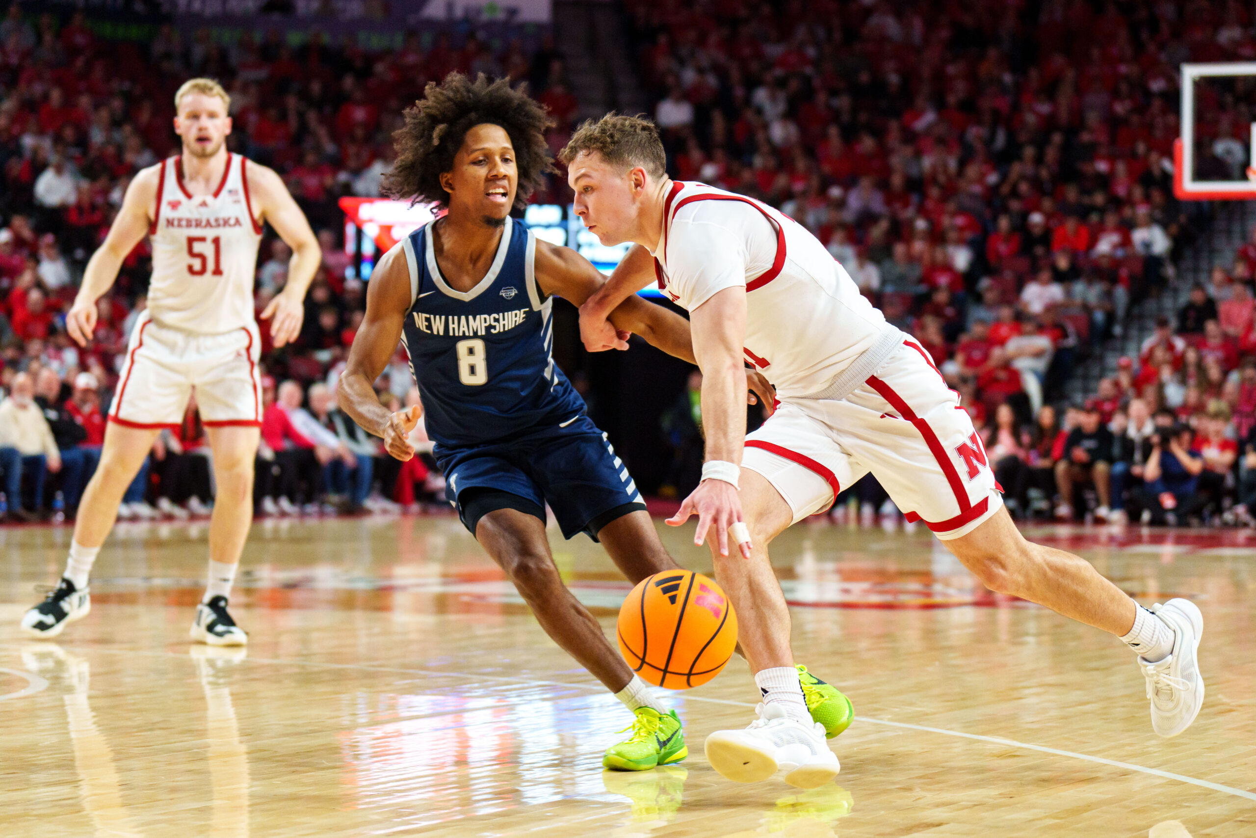 Dec 30, 2025; Lincoln, Nebraska, USA; Nebraska Cornhuskers guard Cale Jacobsen (31) drives agaisnt New Hampshire Wildcats guard Kijan Robinson (8) during the first half at Pinnacle Bank Arena. Mandatory Credit: Dylan Widger-Imagn Images