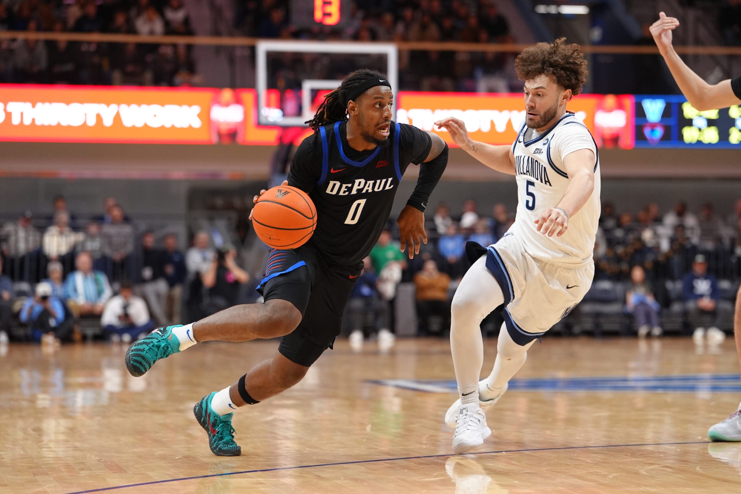 Dec 31, 2025; Villanova, Pennsylvania, USA; DePaul Blue Demons guard Brandon Maclin (0) drives against Villanova Wildcats guard Devin Askew (5) in the second half at William B. Finneran Pavilion. Mandatory Credit: Kyle Ross-Imagn Images
