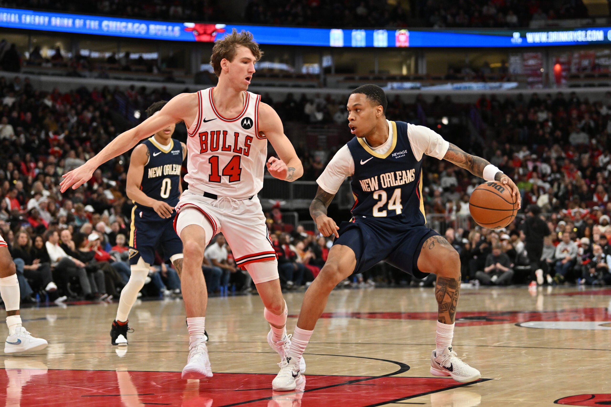 Dec 31, 2025; Chicago, Illinois, USA; New Orleans Pelicans guard Jordan Hawkins (24) controls the ball against Chicago Bulls forward Matas Buzelis (14) during the second half at United Center. Mandatory Credit: Patrick Gorski-Imagn Images