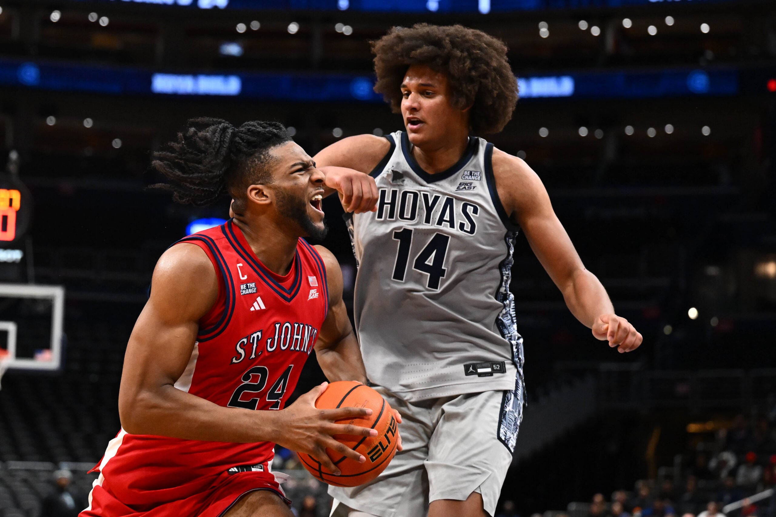 Dec 31, 2025; Washington, District of Columbia, USA; St. John's Red Storm forward Zuby Ejiofor (24) drives to the basket as Georgetown Hoyas center Seal Diouf (14) defends during the first half at Capital One Arena. Mandatory Credit: Brad Mills-Imagn Images