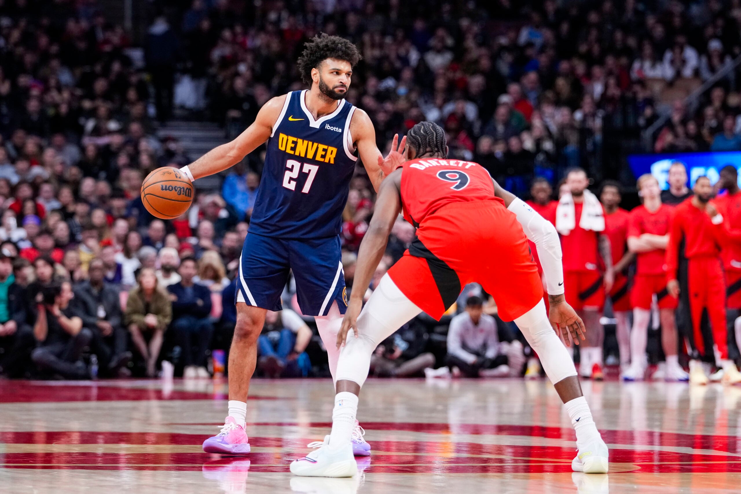 Dec 31, 2025; Toronto, Ontario, CAN; Denver Nuggets guard Jamal Murray (27) dribbles against Toronto Raptors forward/guard RJ Barrett (9) during the second half at Scotiabank Arena. Mandatory Credit: Kevin Sousa-Imagn Images