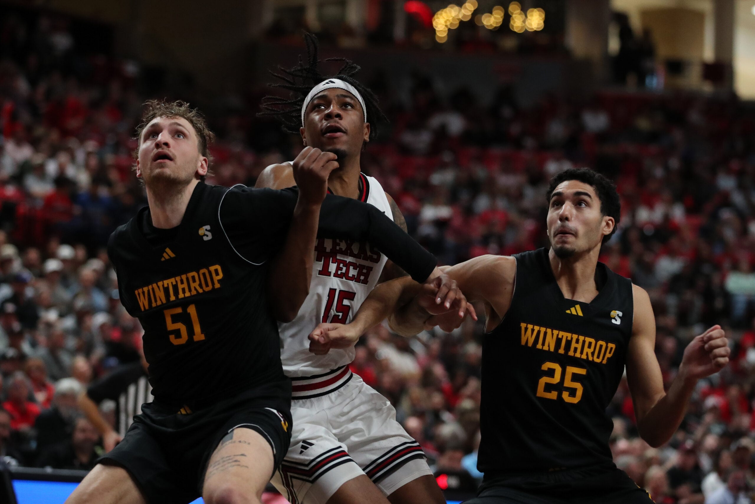 Dec 28, 2025; Lubbock, Texas, USA;  Winthrop Eagles center Logan Duncomb (51) and guard Seifeldin Hendawy (25) fight for position against Texas Tech Red Raiders forward JT Toppin (15) in the second half at United Supermarkets Arena. Mandatory Credit: Michael C. Johnson-Imagn Images