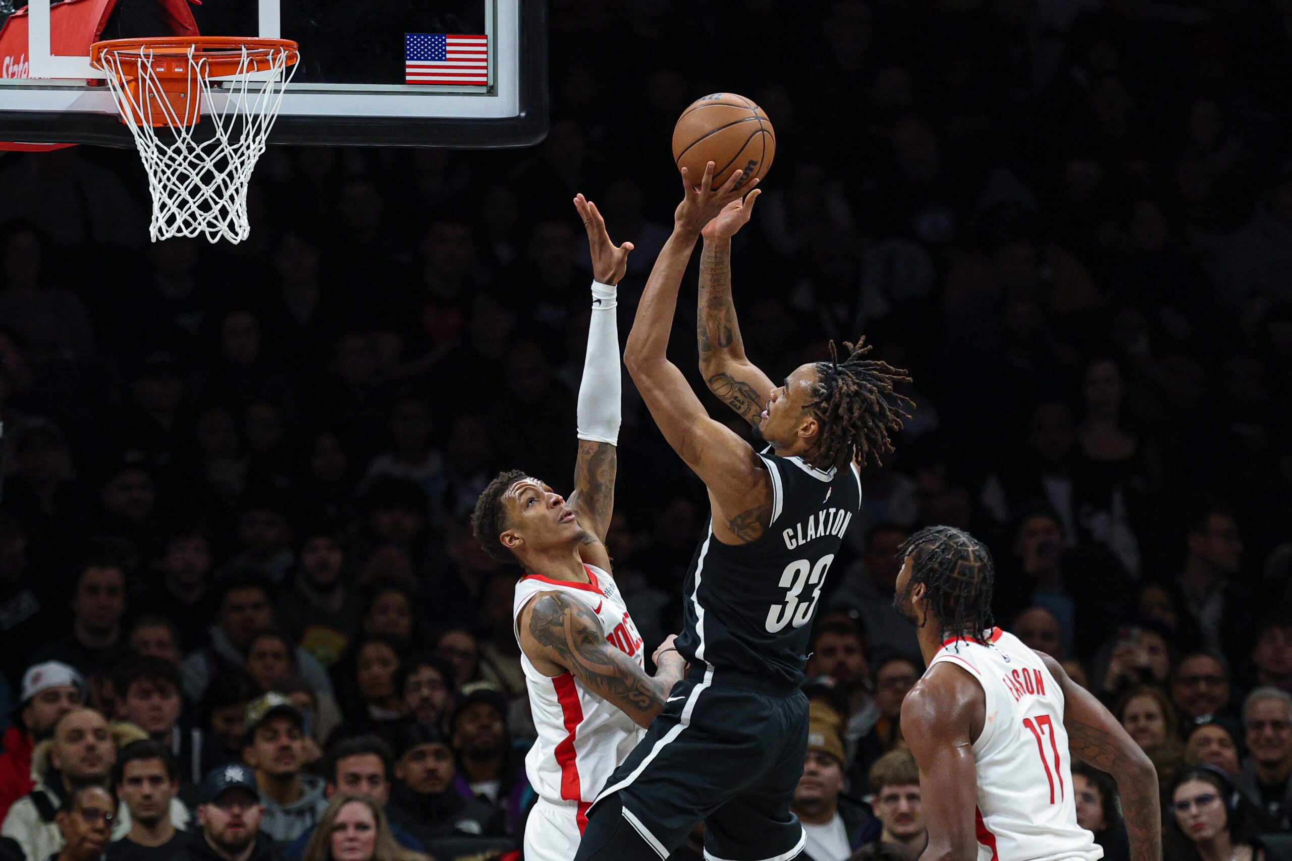Jan 1, 2026; Brooklyn, New York, USA; Brooklyn Nets center Nic Claxton (33) goes to the basket against Houston Rockets forward Jabari Smith Jr. (10) during the second half at Barclays Center. Mandatory Credit: Vincent Carchietta-Imagn Images