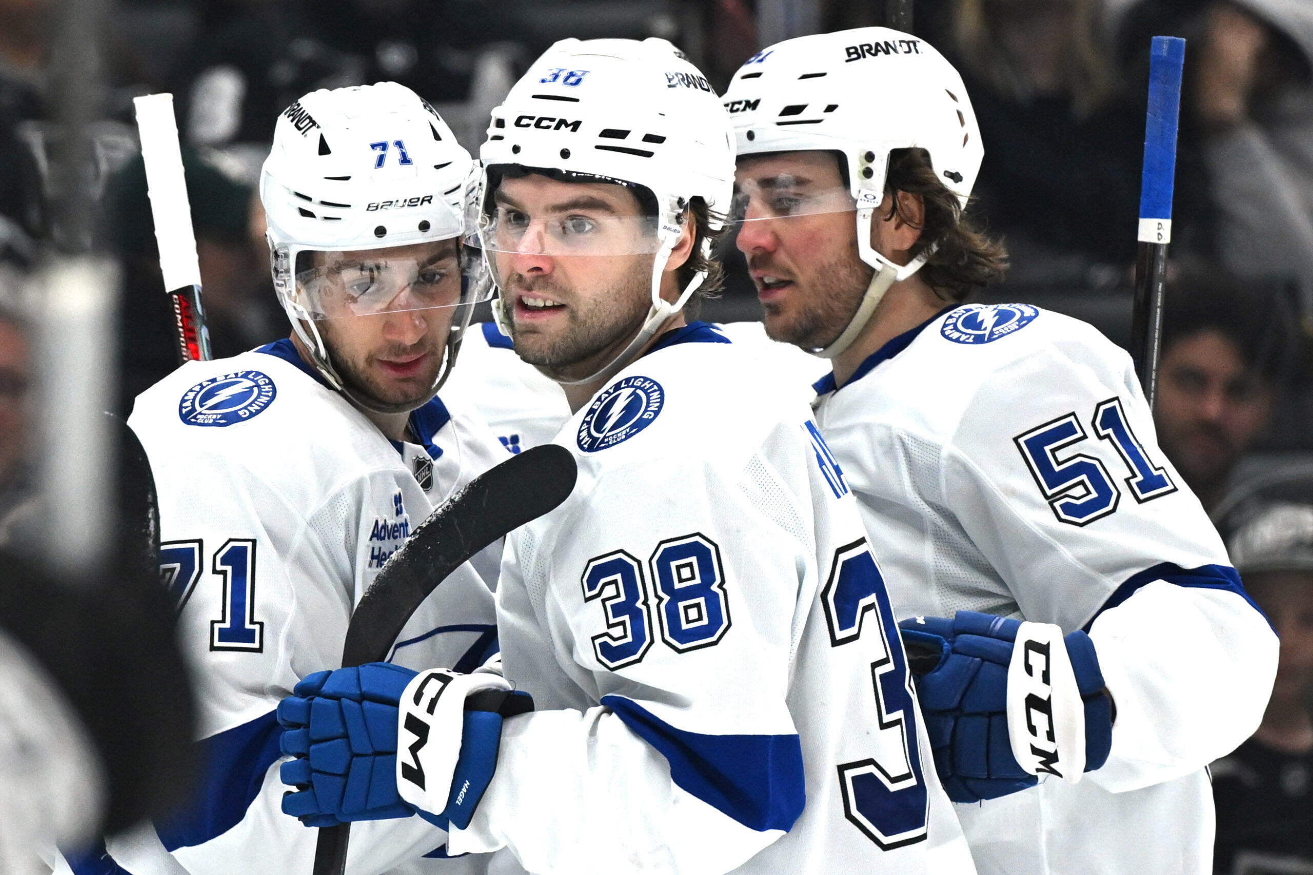 Jan 1, 2026; Los Angeles, California, USA; Tampa Bay Lightning center Anthony Cirelli (71), Tampa Bay Lightning left wing Brandon Hagel (38), and Tampa Bay Lightning defenseman Charle-Edouard D'Astous (51) celebrate a goal during the third period against the Los Angeles Kings at Crypto.com Arena. Mandatory Credit: Griffin Hooper-Imagn Images