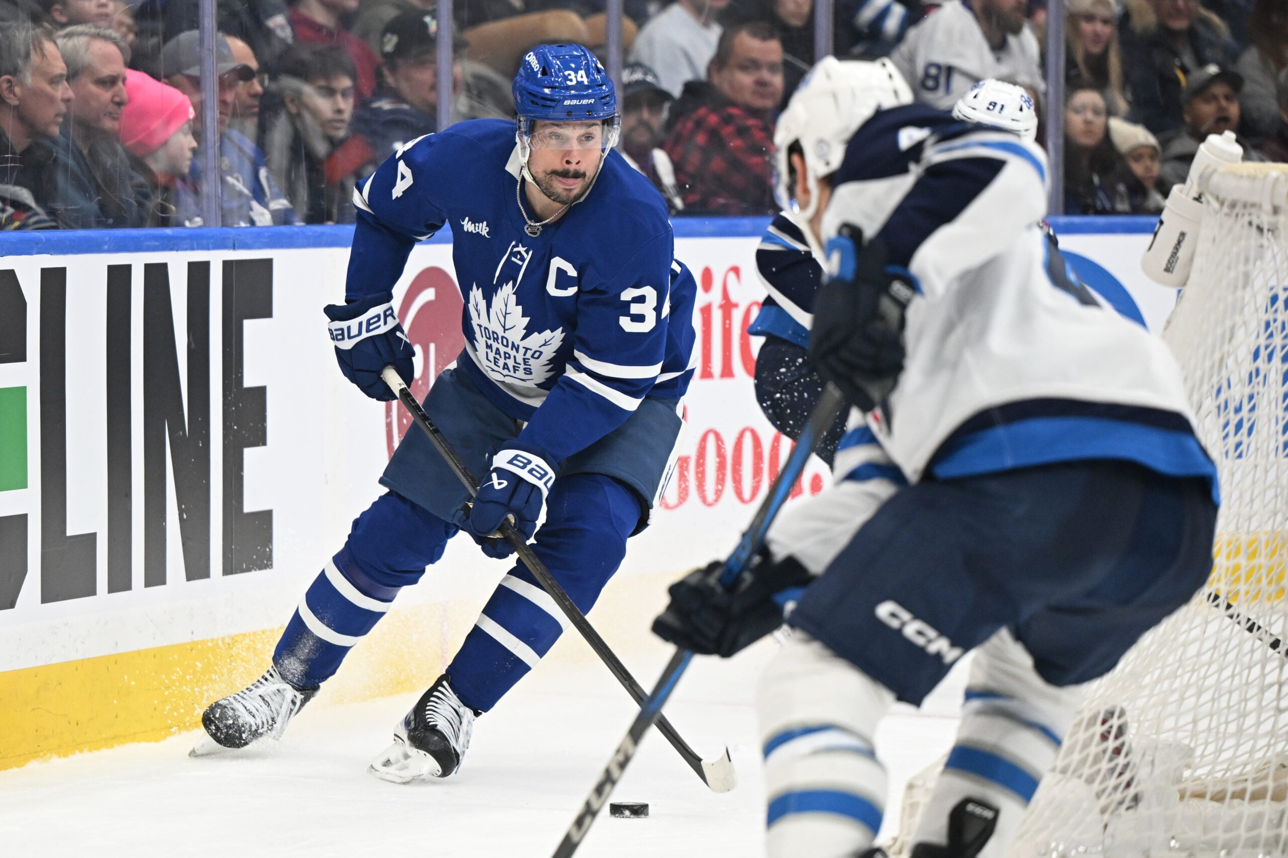 Jan 1, 2026; Toronto, Ontario, CAN; Toronto Maple Leafs forward Auston Matthews (34) controls the puck behind the Winnipeg Jets goal in the third period at Scotiabank Arena. Mandatory Credit: Dan Hamilton-Imagn Images