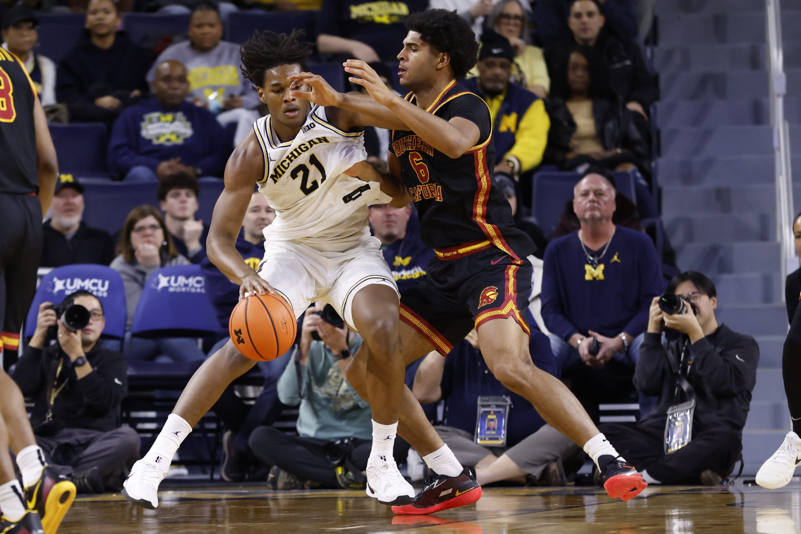 Jan 2, 2026; Ann Arbor, Michigan, USA;  Michigan Wolverines forward Morez Johnson Jr. (21) is defended by Southern California Trojans forward Jacob Cofie (6) in the second half at Crisler Center. Mandatory Credit: Rick Osentoski-Imagn Images