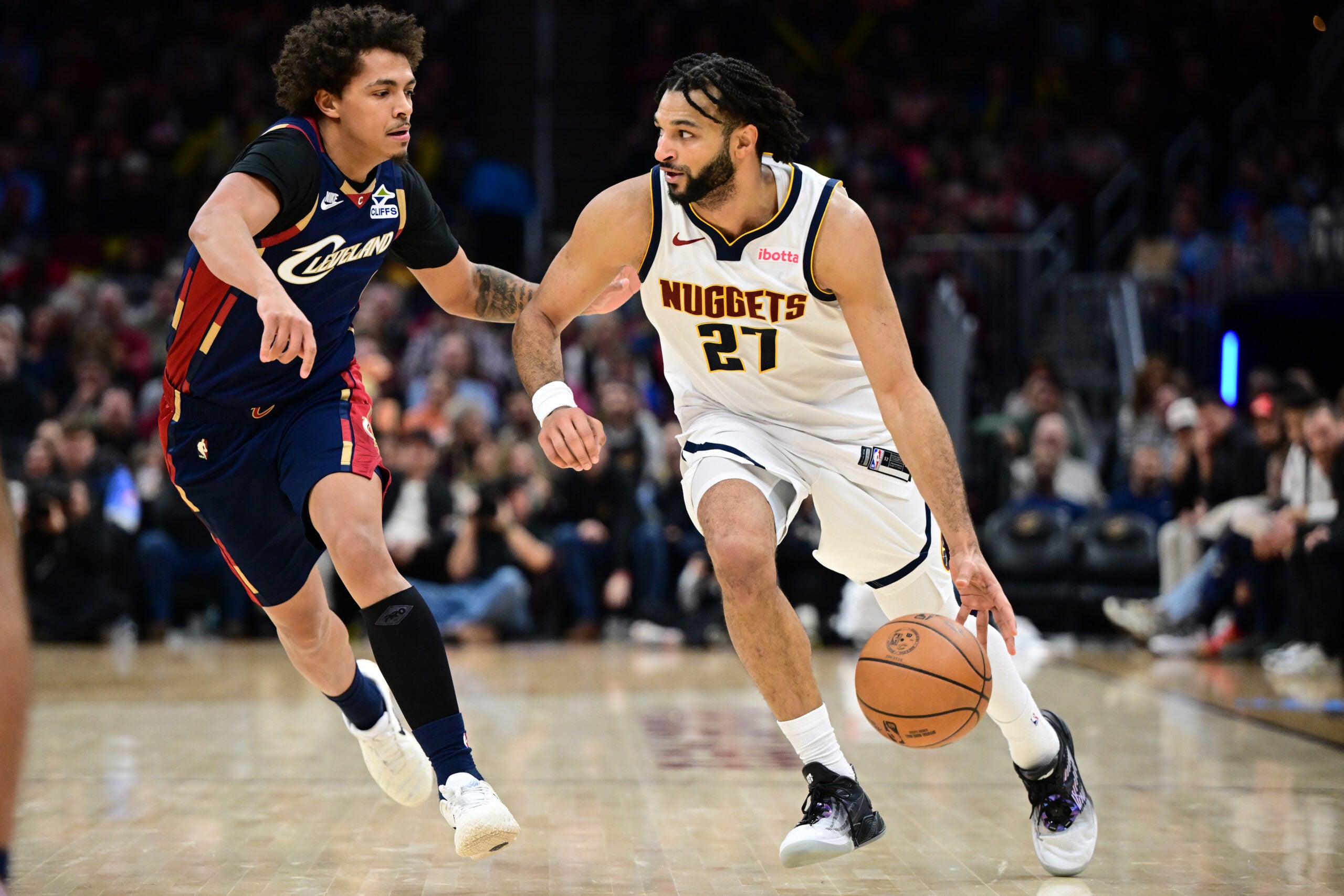 Jan 2, 2026; Cleveland, Ohio, USA; Denver Nuggets guard Jamal Murray (27) drives on Cleveland Cavaliers guard Craig Porter Jr. (9) during the second half at Rocket Arena. Mandatory Credit: David Dermer-Imagn Images