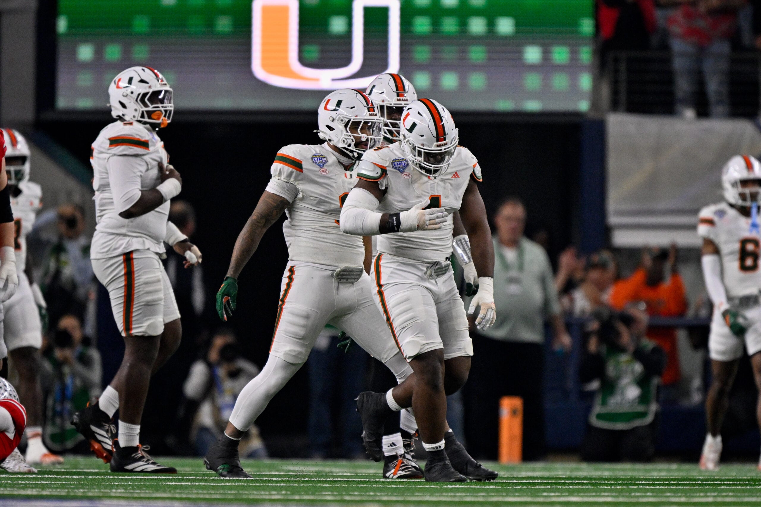 Dec 31, 2025; Arlington, TX, USA; Miami Hurricanes defensive lineman Rueben Bain Jr. (4) and defensive lineman Akheem Mesidor (3) celebrates after sacking Ohio State Buckeyes quarterback Julian Sayin (not pictured) during the 2025 Cotton Bowl and quarterfinal game of the College Football Playoff at AT&T Stadium. Mandatory Credit: Jerome Miron-Imagn Images