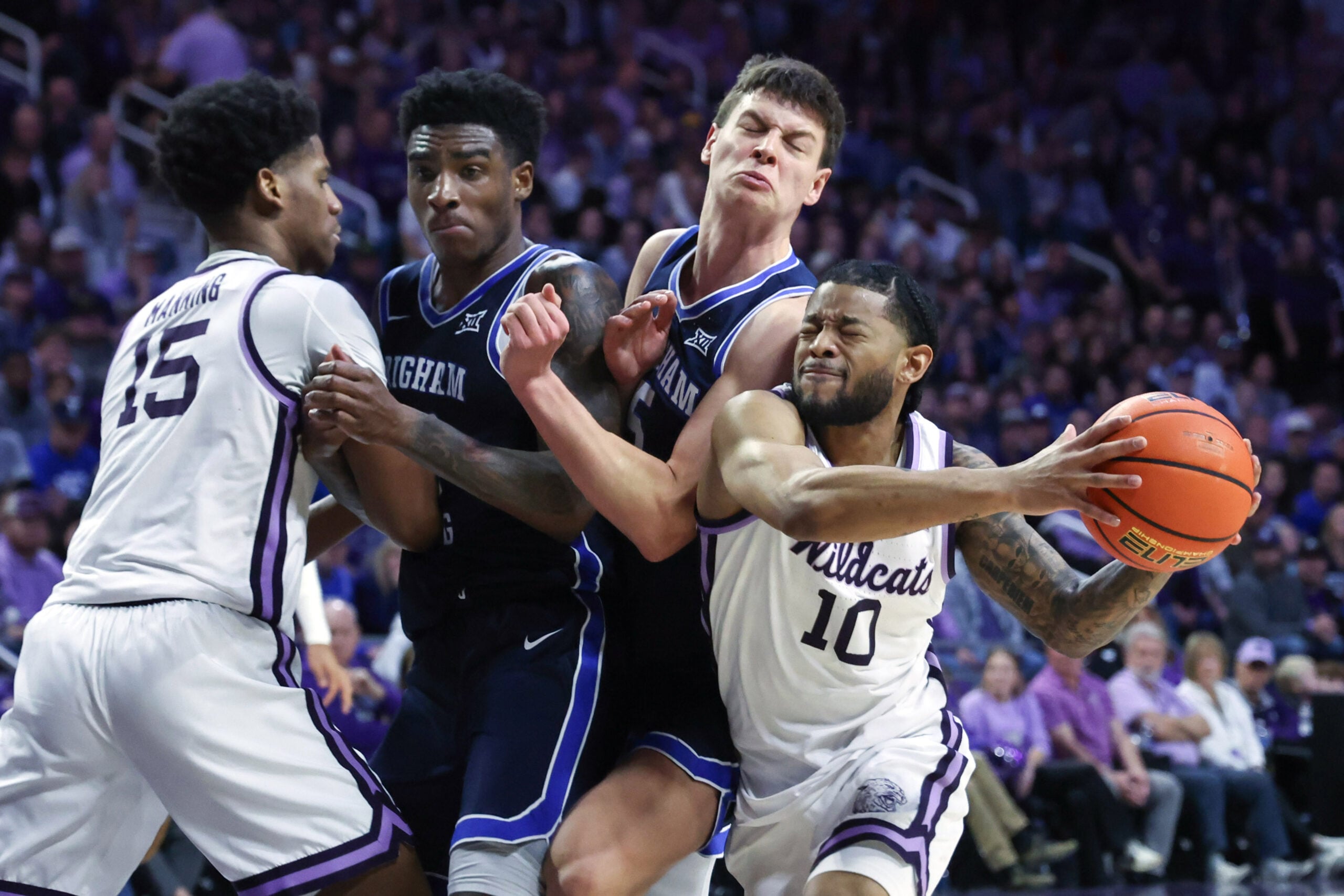 Jan 3, 2026; Manhattan, Kansas, USA; Kansas State Wildcats guard David Castillo (10) goes to the basket against Brigham Young Cougars forwards Mihailo Boskovic (5) and Kennard Davis Jr. (30) during the second half at Bramlage Coliseum. Mandatory Credit: Scott Sewell-Imagn Images