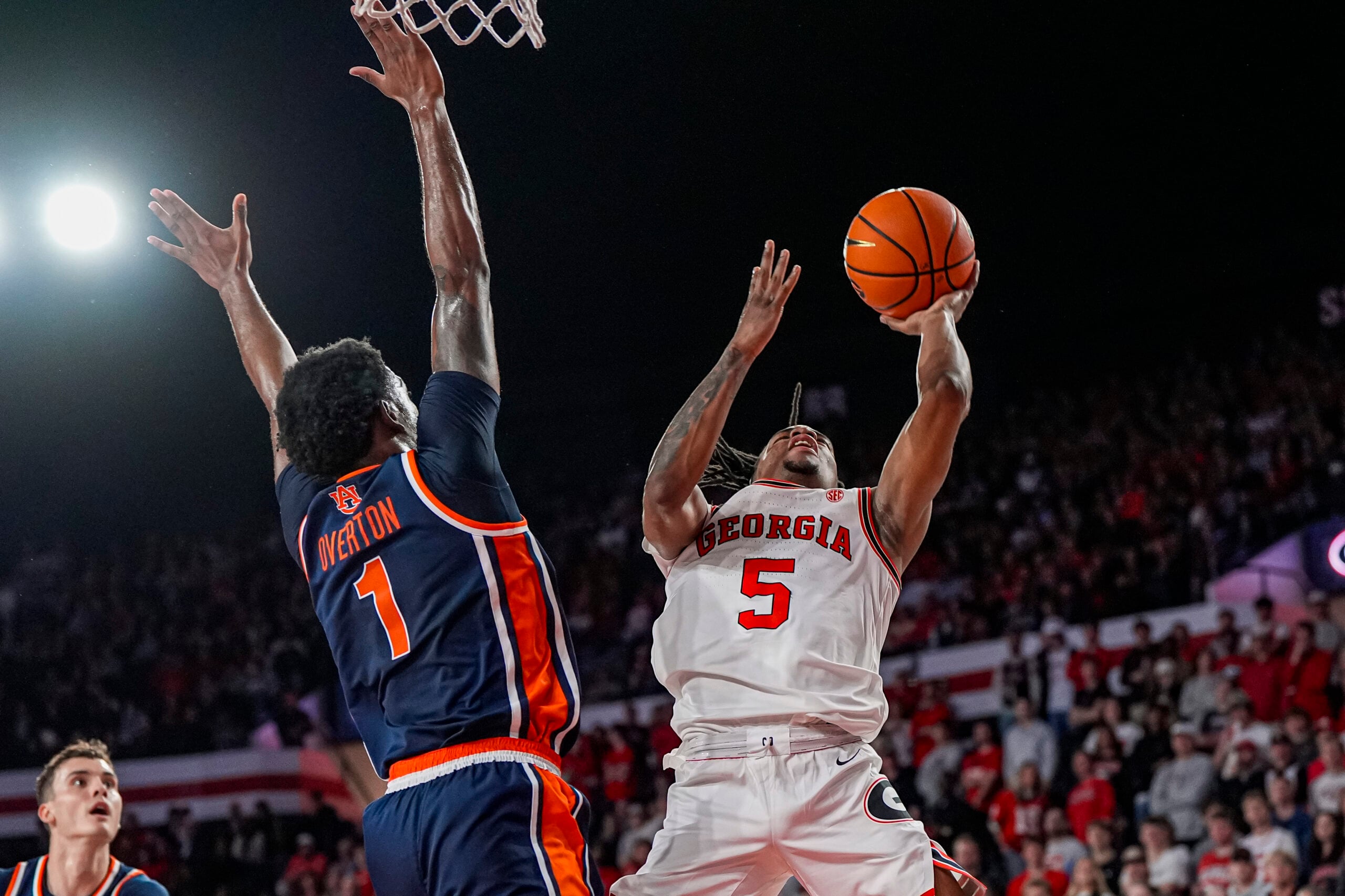 Jan 3, 2026; Athens, Georgia, USA; Georgia Bulldogs guard Jeremiah Wilkinson (5) tries to shoot against Auburn Tigers guard Kevin Overton (1) during the first half at Stegeman Coliseum. Mandatory Credit: Dale Zanine-Imagn Images
