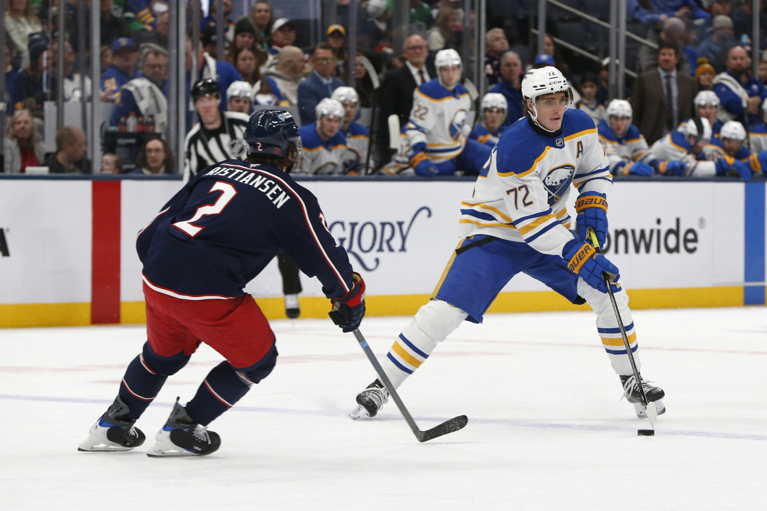 Jan 3, 2026; Columbus, Ohio, USA; Buffalo Sabres center Tage Thompson (72) carries the puck as Columbus Blue Jackets defenseman Jake Christiansen (2) defends during the third period at Nationwide Arena. Mandatory Credit: Russell LaBounty-Imagn Images