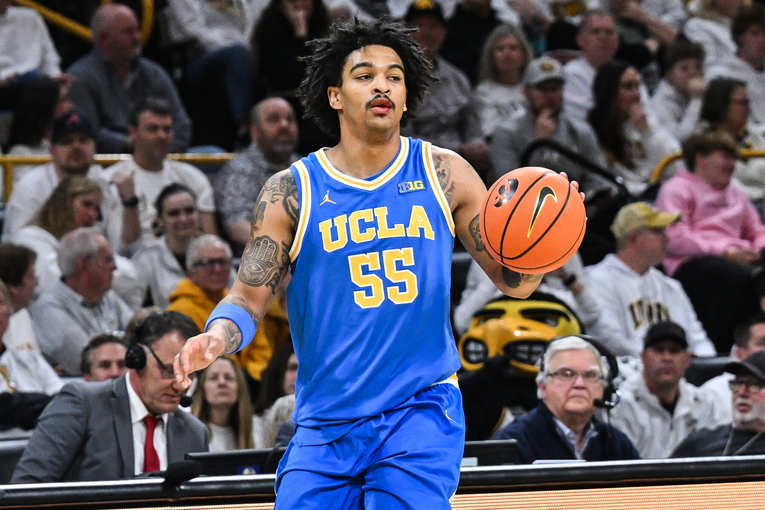 Jan 3, 2026; Iowa City, Iowa, USA; UCLA Bruins guard Skyy Clark (55) controls the ball against the Iowa Hawkeyes during the first half at Carver-Hawkeye Arena. Mandatory Credit: Jeffrey Becker-Imagn Images
