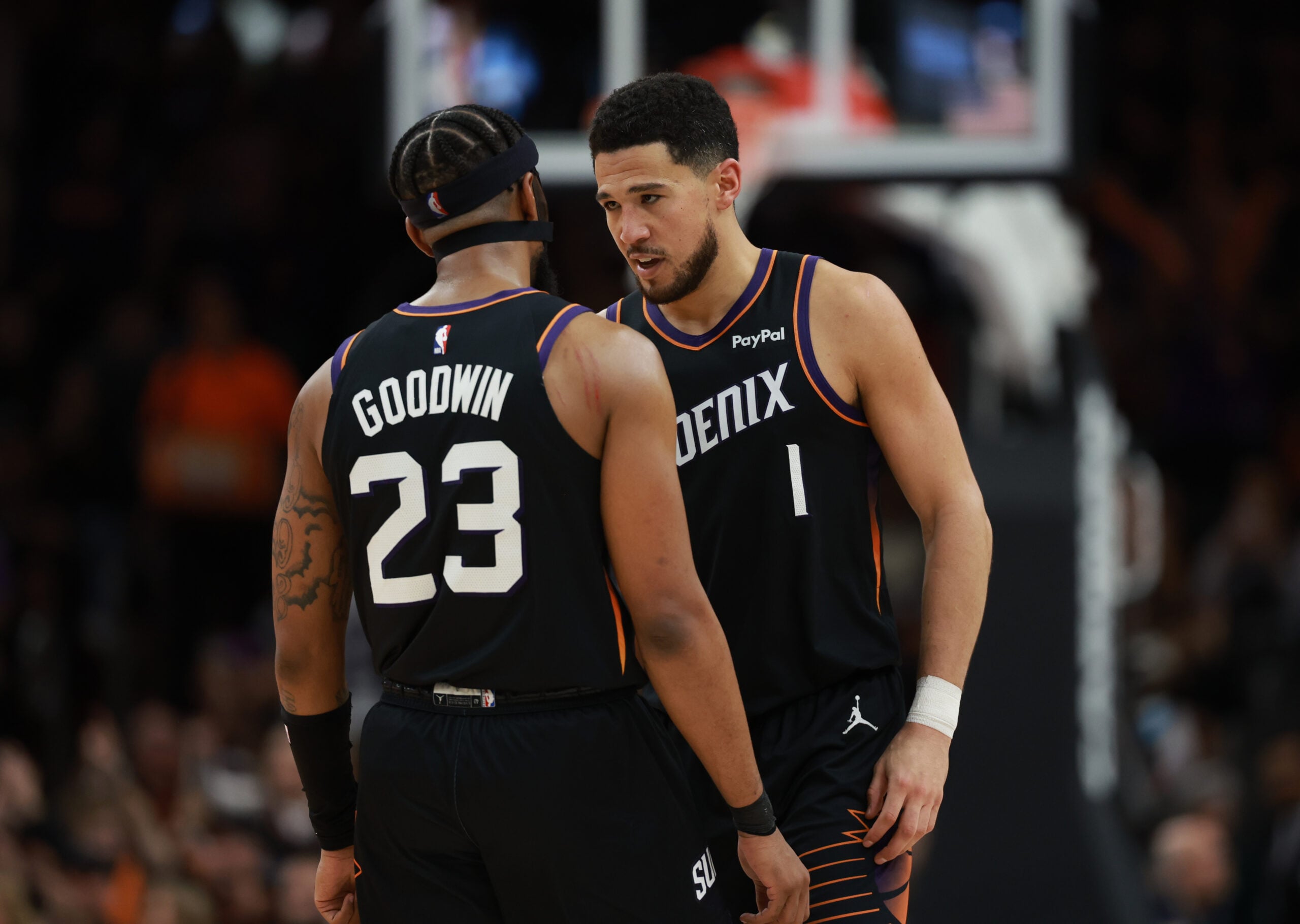 Jan 4, 2026; Phoenix, Arizona, USA; Phoenix Suns guard Devin Booker (1) celebrates with teammate Jordan Goodwin (23) against the Oklahoma City Thunder in the second half at Mortgage Matchup Center. Mandatory Credit: Mark J. Rebilas-Imagn Images