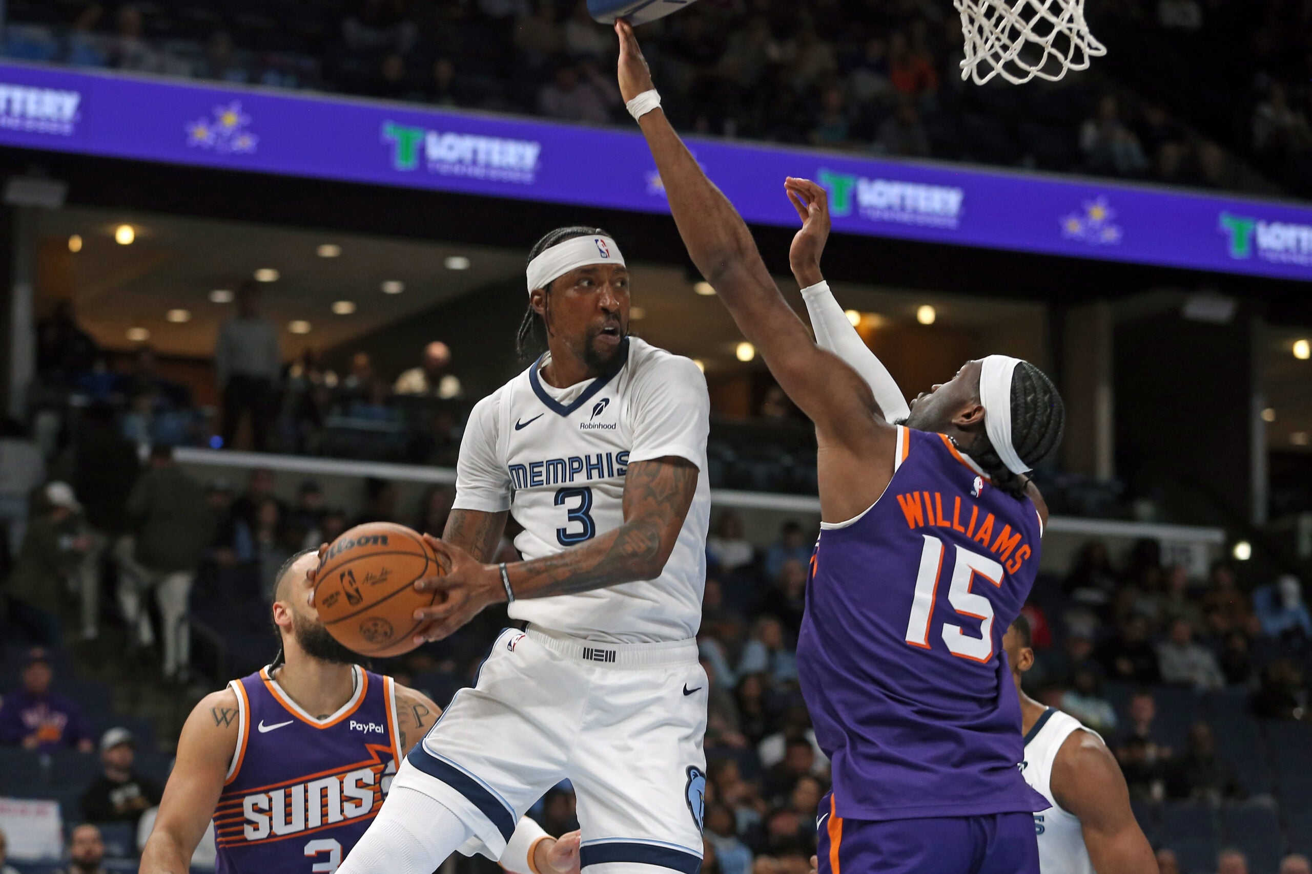 Jan 7, 2026; Memphis, Tennessee, USA; Memphis Grizzlies forward Kentavious Caldwell-Pope (3) passes the ball as Phoenix Suns center Mark Williams (15) defends during the fourth quarter at FedExForum. Mandatory Credit: Petre Thomas-Imagn Images