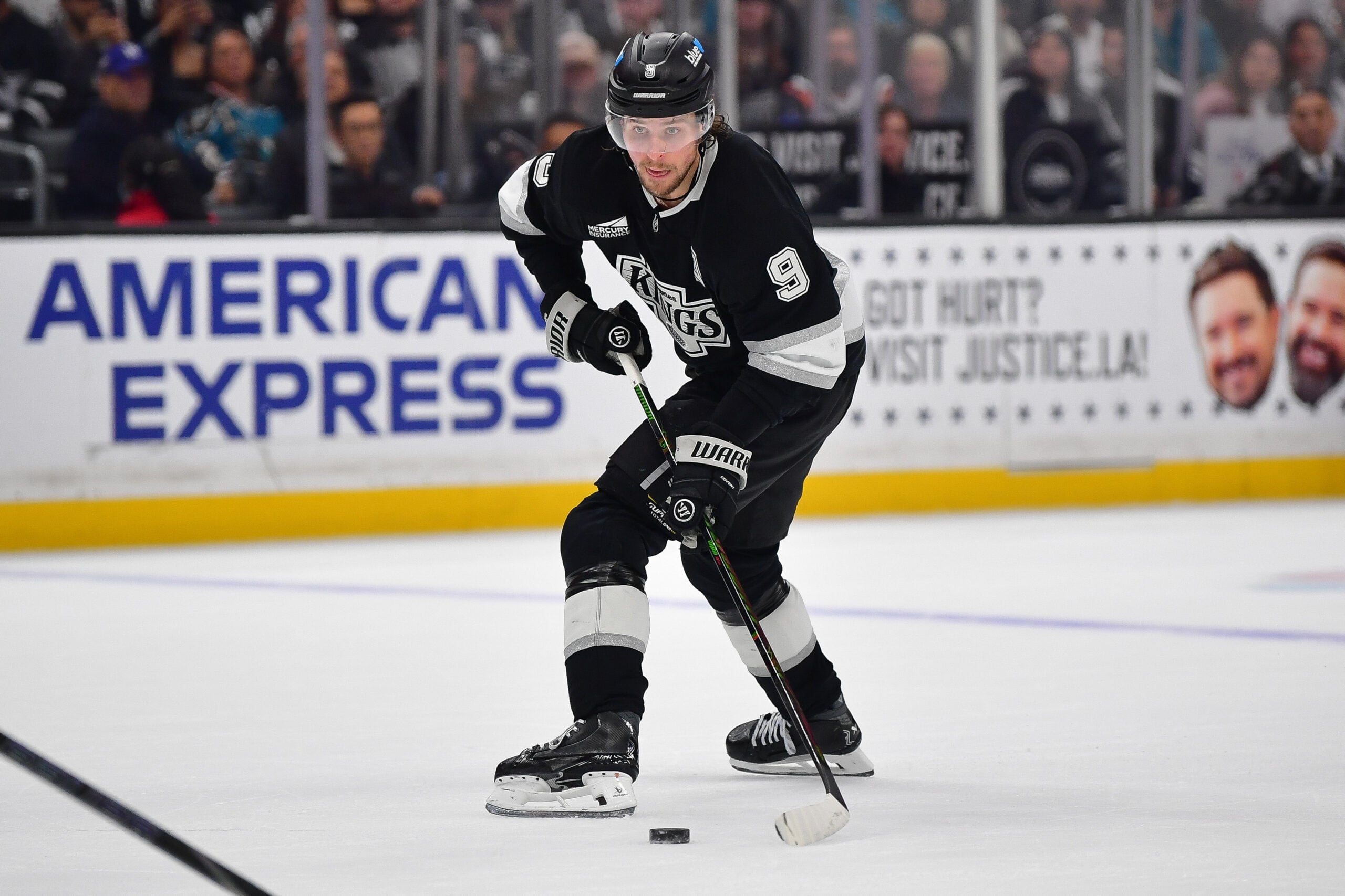 Jan 7, 2026; Los Angeles, California, USA; Los Angeles Kings right wing Adrian Kempe (9) controls the puck against the San Jose Sharks during the overtime period at Crypto.com Arena. Mandatory Credit: Gary A. Vasquez-Imagn Images