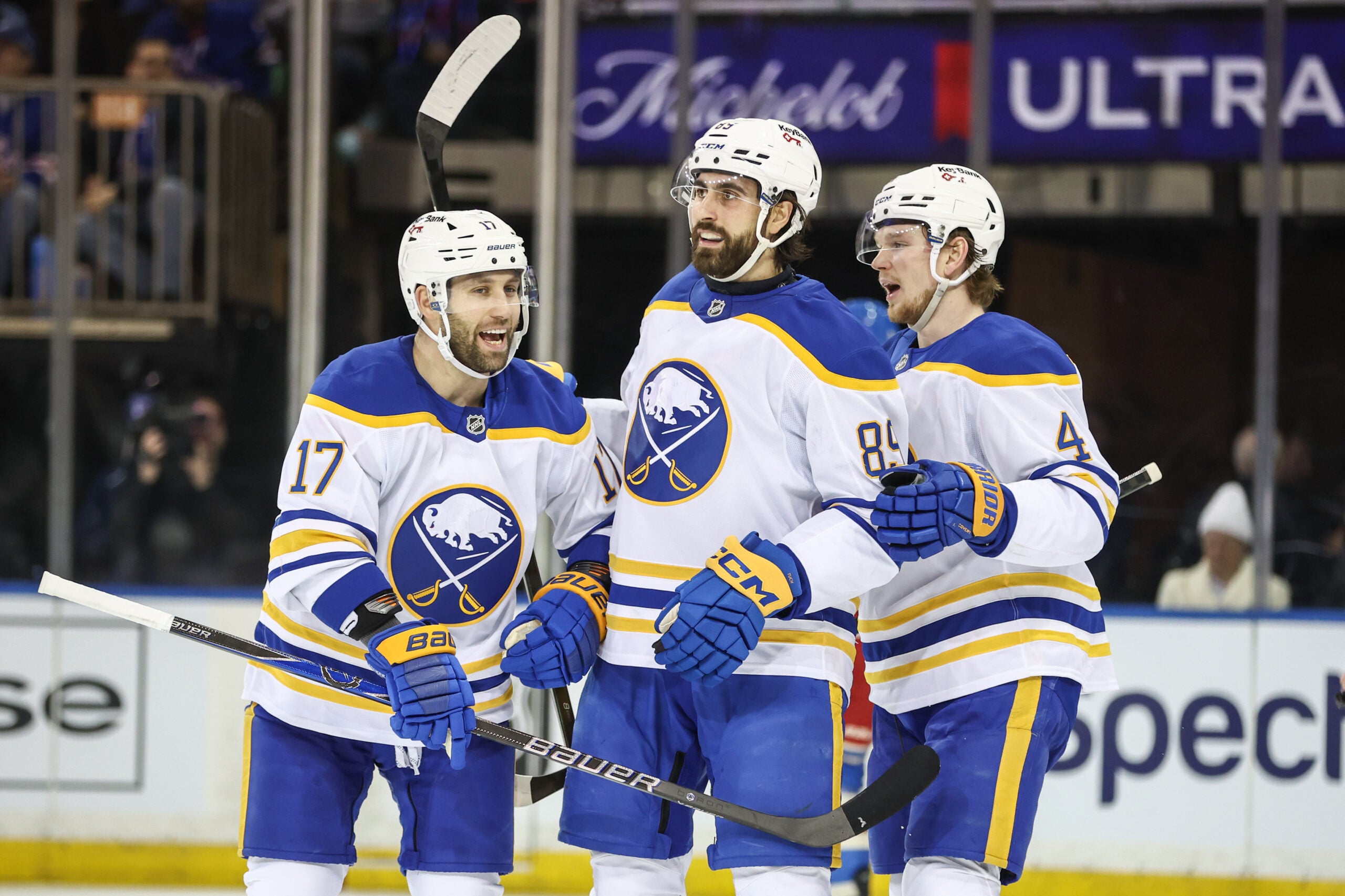 Jan 8, 2026; New York, New York, USA;  Buffalo Sabres right wing Alex Tuch (89) celebrates with left wing Jason Zucker (17) and defenseman Bowen Byram (4) after scoring a goal in the second period against the New York Rangers at Madison Square Garden. Mandatory Credit: Wendell Cruz-Imagn Images